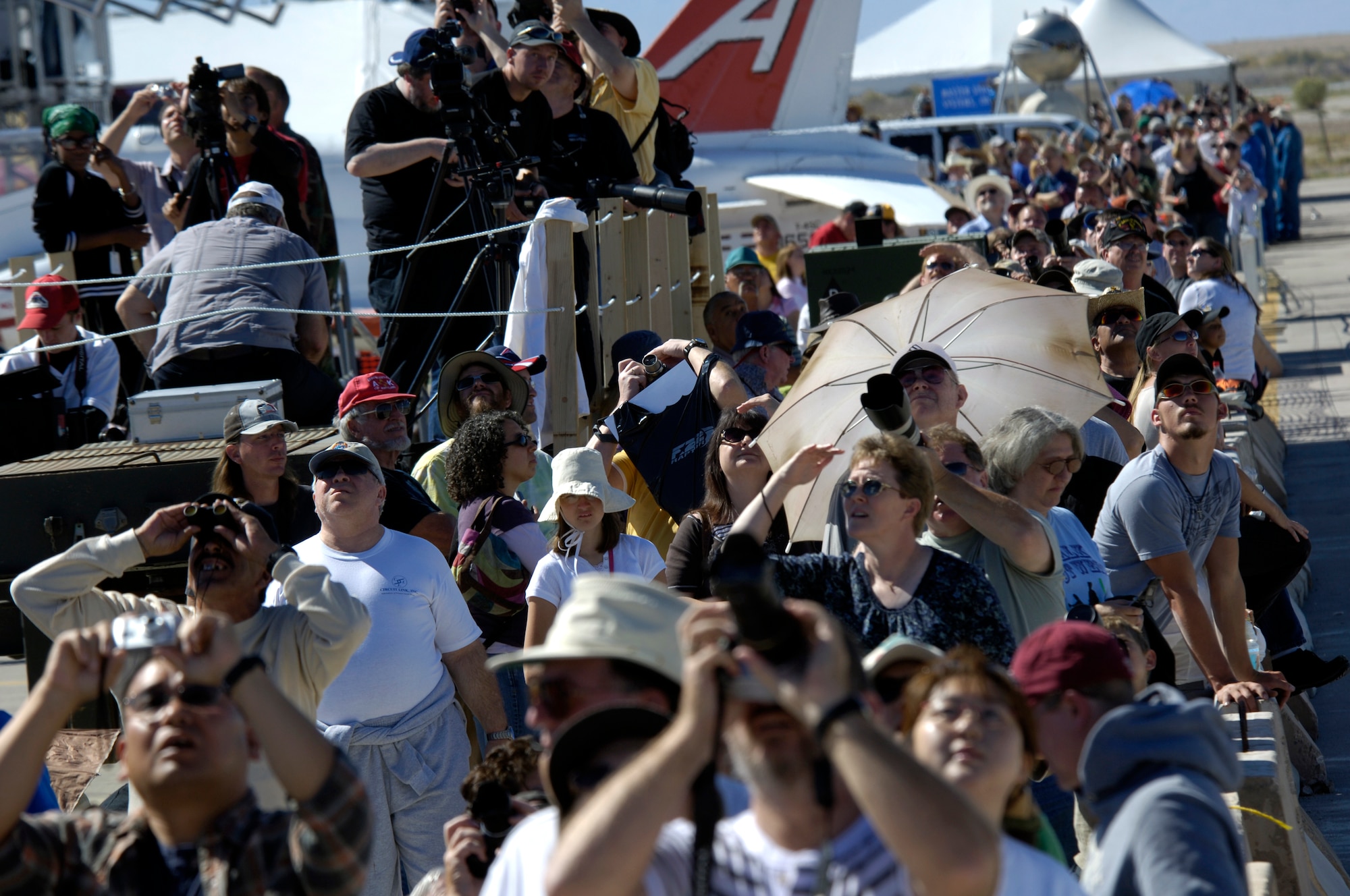 Spectators watch aircraft and parachutist perform during the Holloman Air and Space Expo on October 27 2007. The Holloman Air and Space Expo is a showcase of Air Force capabilities, the 49th Fighter Wing mission and the X Prize Foundation (U.S. Air Force Photo by Staff Sgt Jason Colbert)