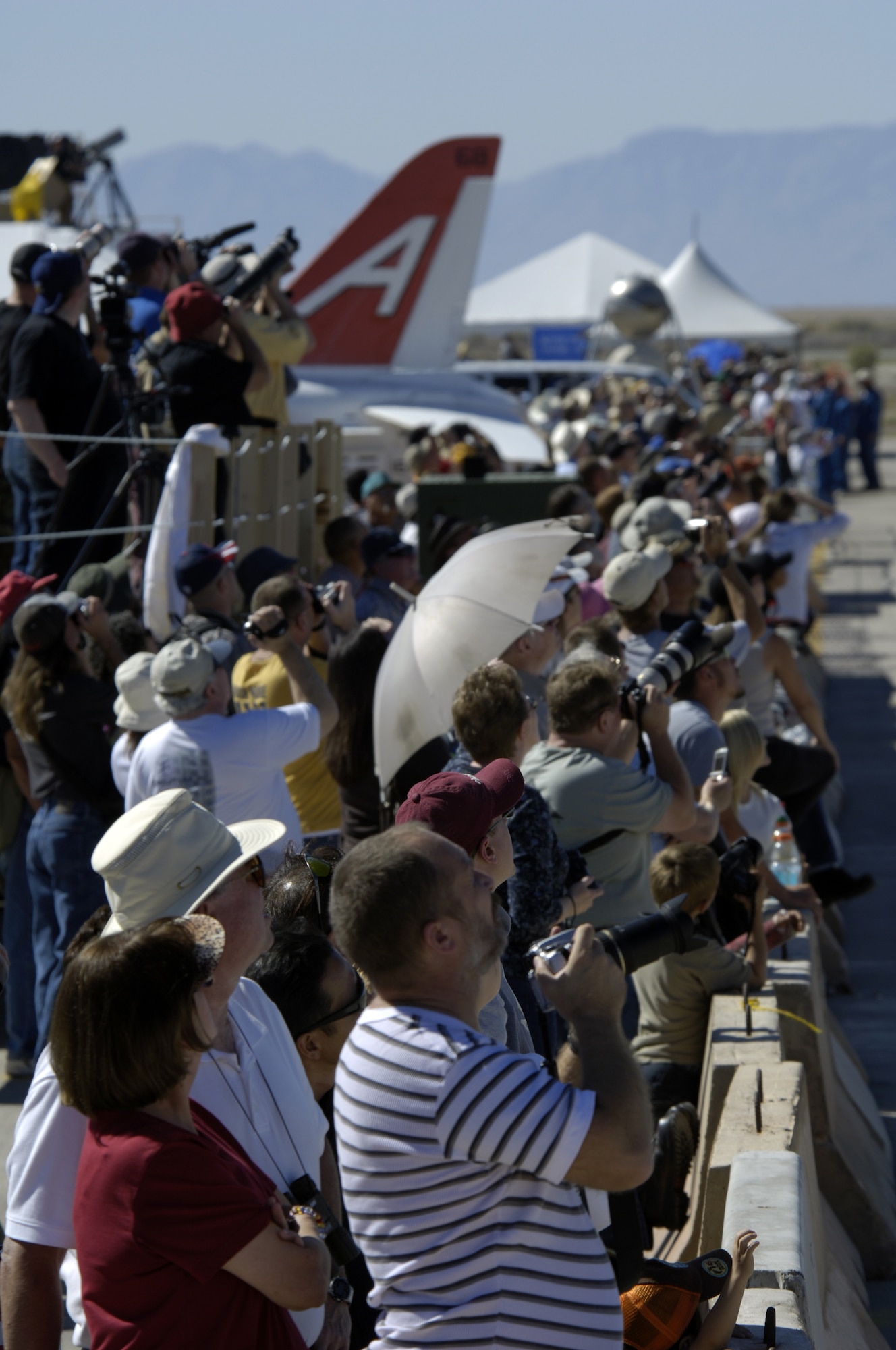 Spectators watch aircraft and parachutist perform during the Holloman Air and Space Expo on October 27 2007. The Holloman Air and Space Expo is a showcase of Air Force capabilities, the 49th Fighter Wing mission and the X Prize Foundation (U.S. Air Force Photo by Staff Sgt Jason Colbert)