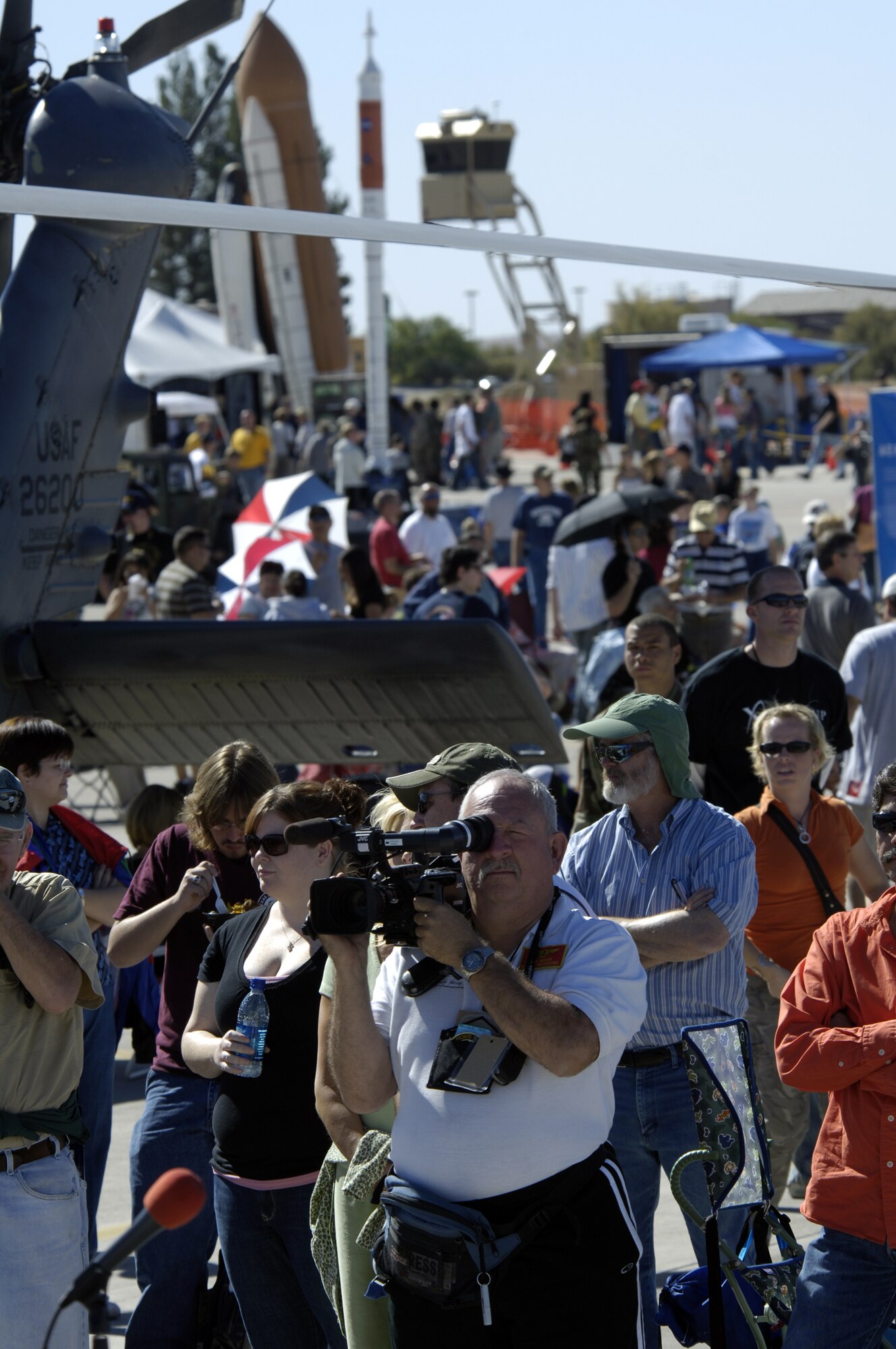 Spectators watch aircraft and parachutist perform during the Holloman Air and Space Expo on October 27 2007. The Holloman Air and Space Expo is a showcase of Air Force capabilities, the 49th Fighter Wing mission and the X Prize Foundation (U.S. Air Force Photo by Staff Sgt Jason Colbert)