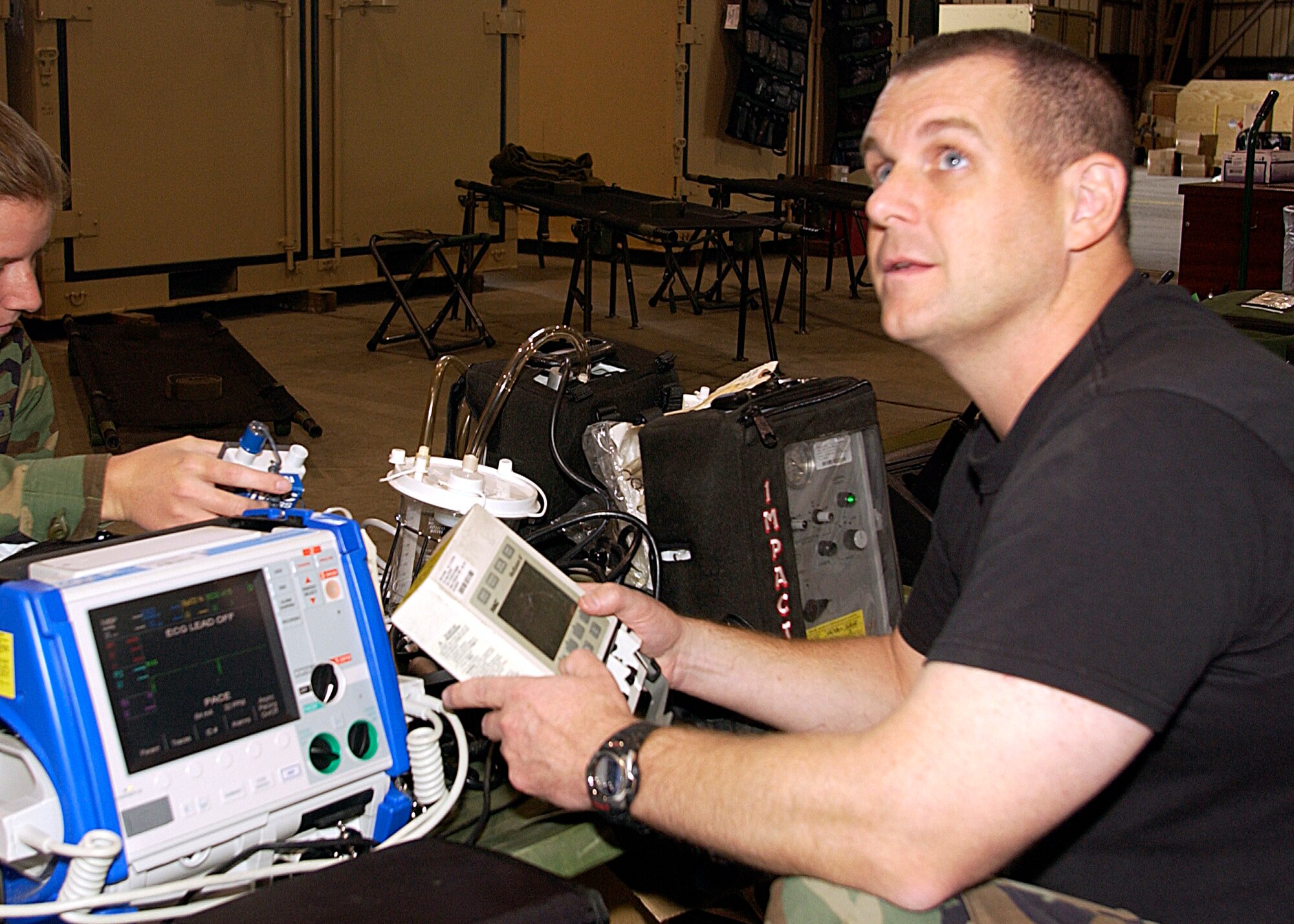 Major Kerry Barshinger, a flight nurse from the 43rd AES, Pope ARB, N.C., performs an inspection on a cardiac monitor while assigned to a Mobile Aeromedical Staging Facility at March Air Reserve Base, Calif., in support of medical relief efforts for the California wildfires.  The facility waits on standby to air-evacuate fire victims out of the local area. (U.S. Air Force photos by Senior Airman David Flaherty/452 AMW/PA)
