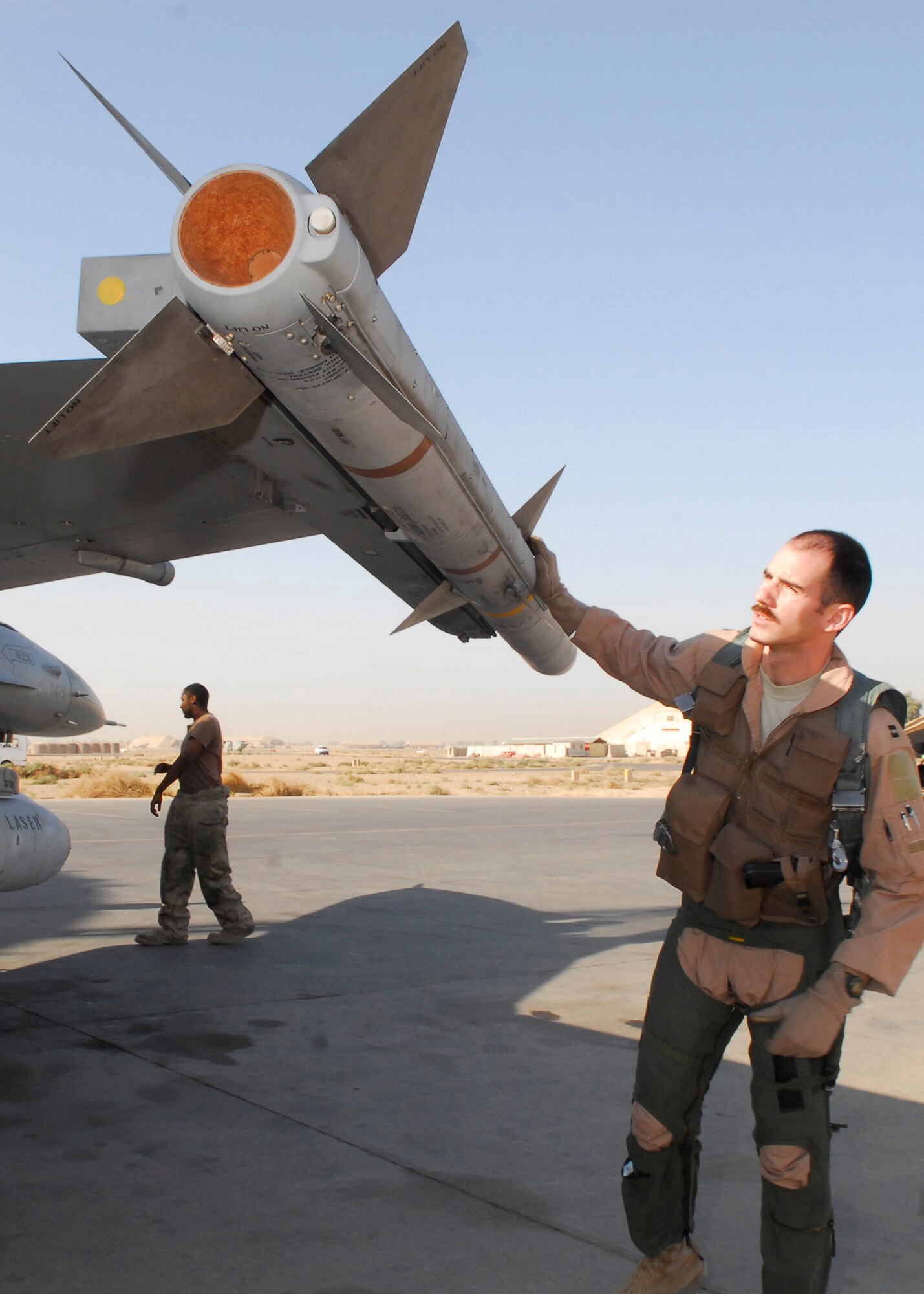 BALAD AIR BASE, Iraq -- Capt. Thomas "Shack" Graham, 4th Expeditionary Fighter Squadron, checks the munitions on his F-16 Fighting Falcon as apart of his pre-flight inspection. (U.S. Air Force photo/Staff Sgt. Joshua Garcia) 