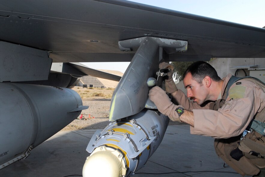 BALAD AIR BASE, Iraq -- Capt. Thomas "Shack" Graham, 4th Expeditionary Fighter Squadron, inspects the locking mechanism from the F-16 Fighting Falcon to the munitions ensuring that it is properly functioning. Any discrepancies could halt a mission, so they need to be addressed prior to takeoff. Captain Graham is deployed from Hill Air Force Base, Utah. (U.S. Air Force photo/Staff Sgt. Joshua Garcia)