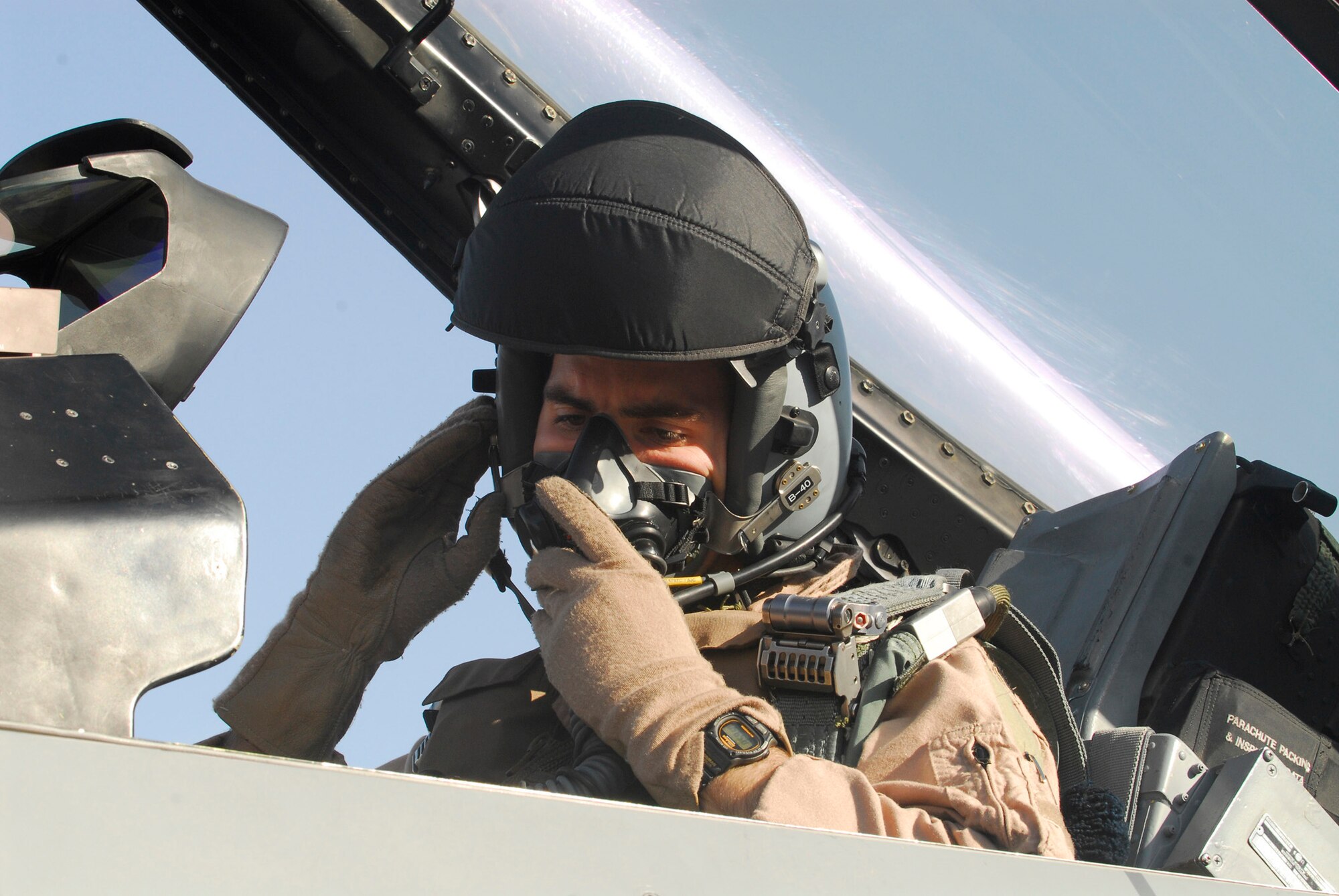 BALAD AIR BASE, Iraq -- Capt. Thomas "Shack" Graham, 4th Expeditionary Fighter Squadron, secures his HGU-55/P Aircrew Helmet. The helmet allows Captain Graham to receive a constant flow of fresh oxygen while in the aircraft, as well as communicate with ground personnel during flight. Captain Graham is deployed from Hill Air Force Base, Utah. (U.S. Air Force photo/Staff Sgt. Joshua Garcia)
