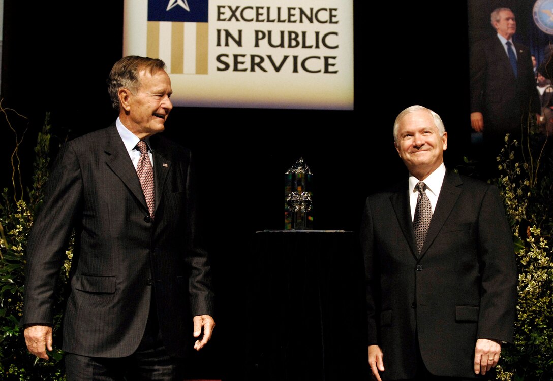Former President George H. W. Bush presents Secretary of Defense Robert M. Gates with the George Bush Award for Excellence in Public Service during a ceremony at Reed Arena in College Station, Texas, Oct. 26, 2007. 