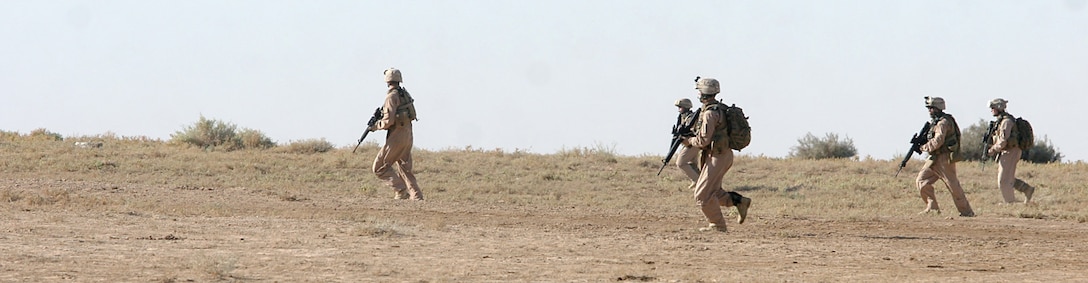 AL ASAD AIR BASE, Iraq, -- Marines with Regimental Combat Team 2’s Aero Scout team rush to search a small Bedouin tent. Aero Scout, technically a large squad of the provisional rifle platoon, is a mix of military occupational specialties ranging from infantry to administration. The team uses helicopters to quickly search areas of interest, and scout out possible targets. Official Marine Corps Photo By Cpl. Ryan C. Heiser.