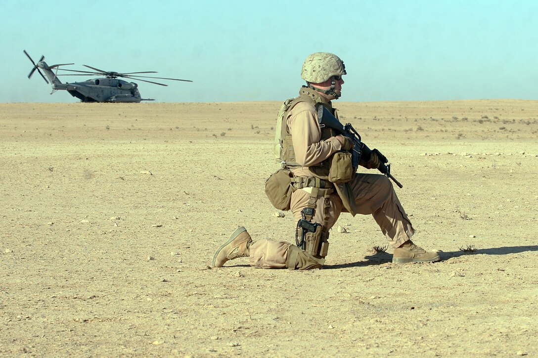 AL ASAD AIR BASE, Iraq, -- Petty Officer 2nd Class Jason S. Gamble, a Corpsman with Regimental Combat Team 2’s Aero Scout team, provides security while the rest of the team serches a group of Bedouin tents. Aero Scout, technically a large squad of the provisional rifle platoon, is a mix of military occupational specialties ranging from infantry to administration. The team uses helicopters to quickly search areas of interest, and scout out possible targets. Official Marine Corps Photo By Cpl. Ryan C. Heiser.