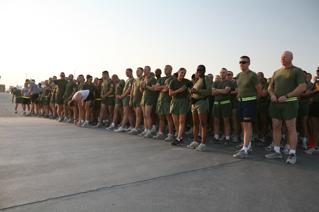 AL TAQADDUM, Iraq (Oct. 28, 2007) ? Service members and civilian contractors aboard Al Taqaddum stand behind the starting line near the Lakeside Chapel prior to beginning the Halloween 5k run Oct. 28.  Nearly 500 participants ran.