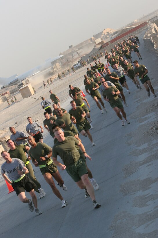 AL TAQADDUM, Iraq (Oct. 28, 2007) ? Service members and civilians aboard Al Taqaddum rush to reach the finish line of the Halloween 5k run Oct. 28.  Nearly 500 Marines, sailors, soldiers and civilian contractors participated in the event.