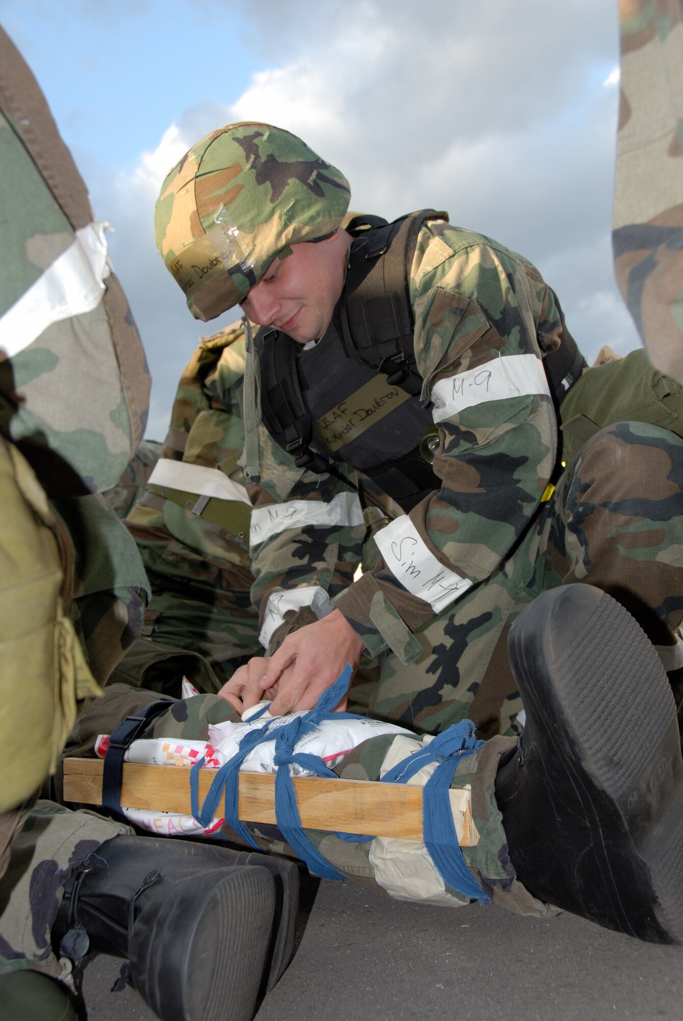 MISAWA AIR BASE, Japan -- Senior Airman Alexander Doubrov, 35th Civil Engineering Squadron, performs self aid and buddy care on a simulated injury during exercise Beverly Sunrise 08-01on Oct. 23, 2007.  This exercise was designed to assess the base's war fighting capabilities.  (U.S. Air Force photo by Senior Airman Laura R. McFarlane)(RELEASED)