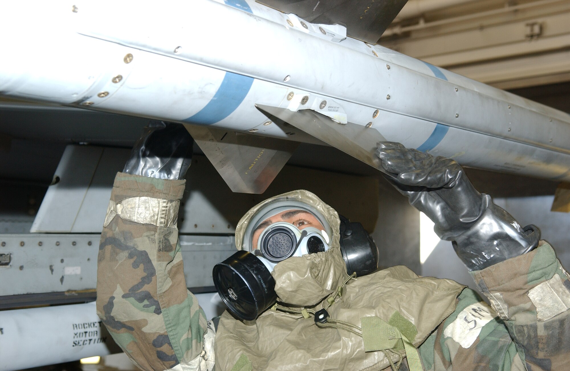 MISAWA AIR BASE, Japan -- Staff Sgt. Juan Reyes, 35th Aircraft Maintenance Squadron weapons crew 32, inspects a missile on an F-16 on the flightline on Oct. 24, 2007 during exercise Beverly Sunrise 08-01.  This exercise is designed to assess the base's war fighting capabilities. (U.S. Air Force photo by Senior Airman Robert Barnett)(RELEASED)