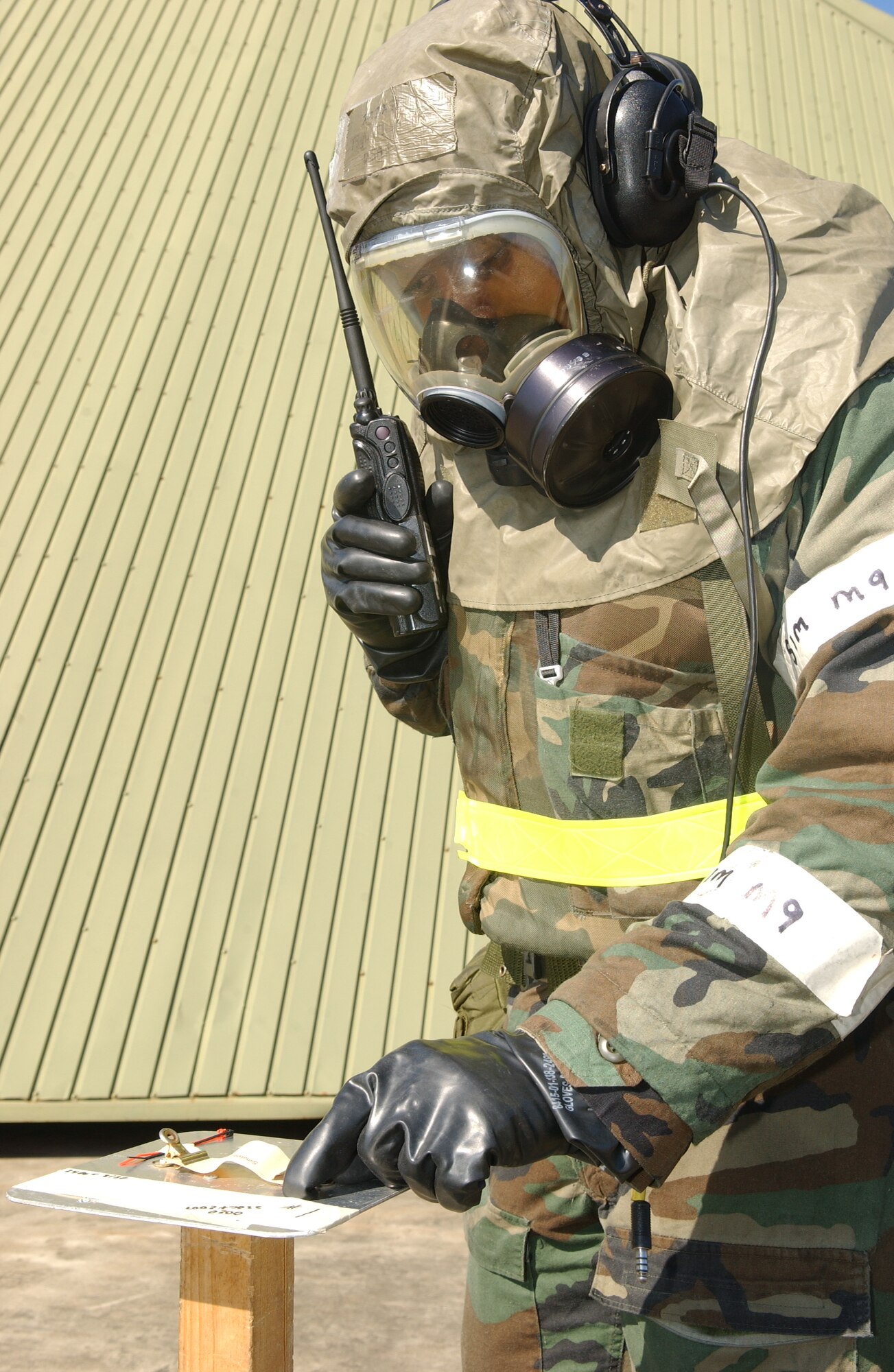 MISAWA AIR BASE, Japan -- Tech. Sgt. Ethan Thomas, 35th Aircraft Maintenance Squadron crew chief, reports the results of his M-8 contamination inspection on the flightline Oct. 24, 2007 during exercise Beverly Sunrise 08-01.  This exercise is designed to assess the base's war fighting capabilities. (U.S. Air Force photo by Senior Airman Robert Barnett)(RELEASED)