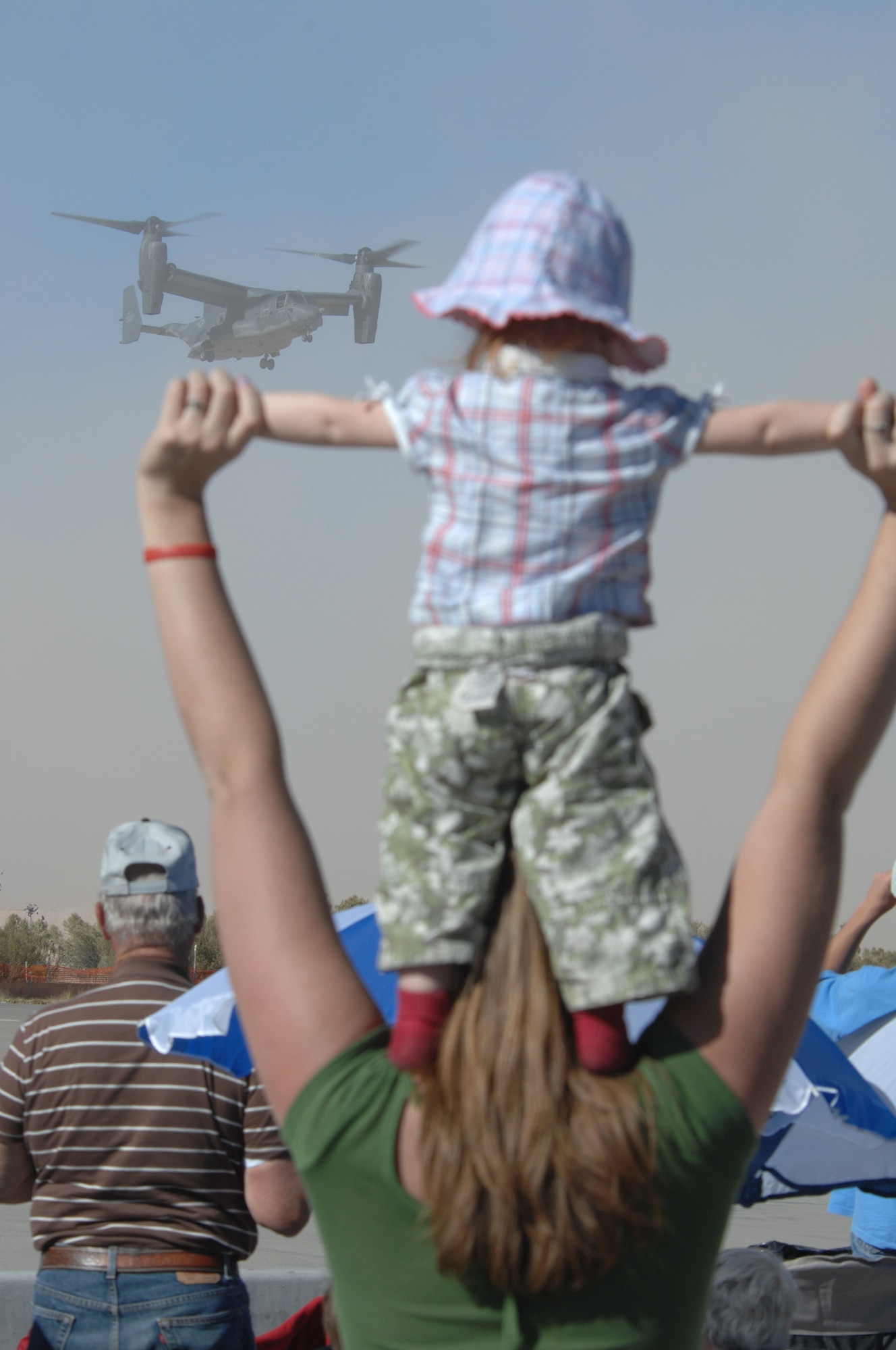 One-and-a-half-year old Emilee Oechsner of Alamogordo, N.M., watches a CV-22 Osprey demonstration Oct. 28, 2007, during the Holloman Air and Space Expo. The HASE is a showcase of Air Force capabilities, the 49th Fighter Wing mission and the X Prize Foundation. (U.S. Air Force photo by Airman 1st Class Jamal Sutter)