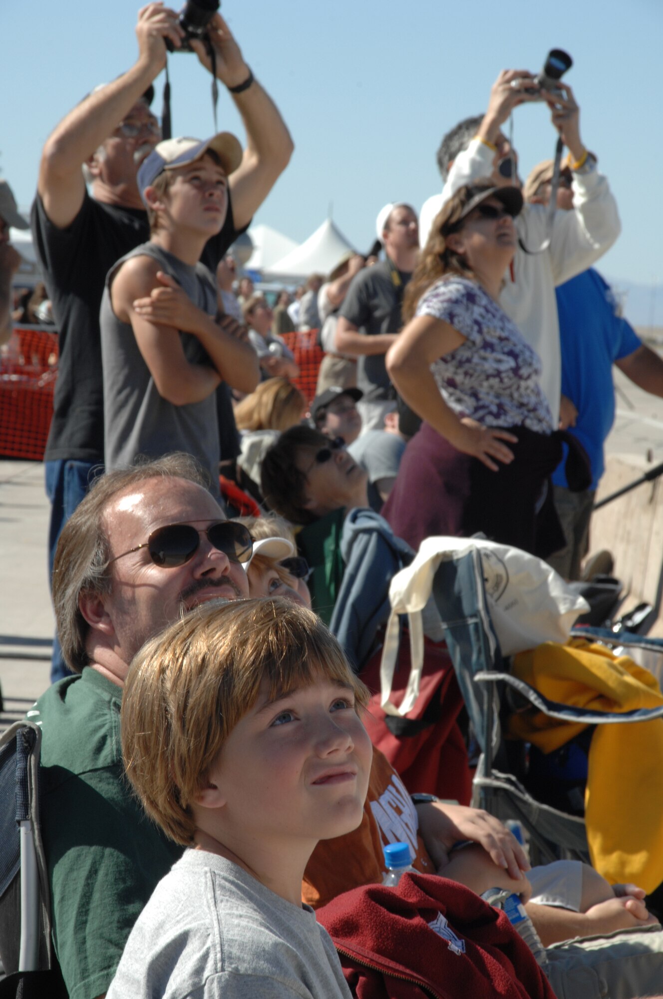 Members of the Alamogordo community and surrounding New Mexico areas watch an aircraft demonstration Oct. 28, 2007, during the Holloman Air and Space Expo. The HASE is a showcase of Air Force capabilities, the 49th Fighter Wing mission and the X Prize Foundation. (U.S. Air Force photo by Airman 1st Class Jamal Sutter)