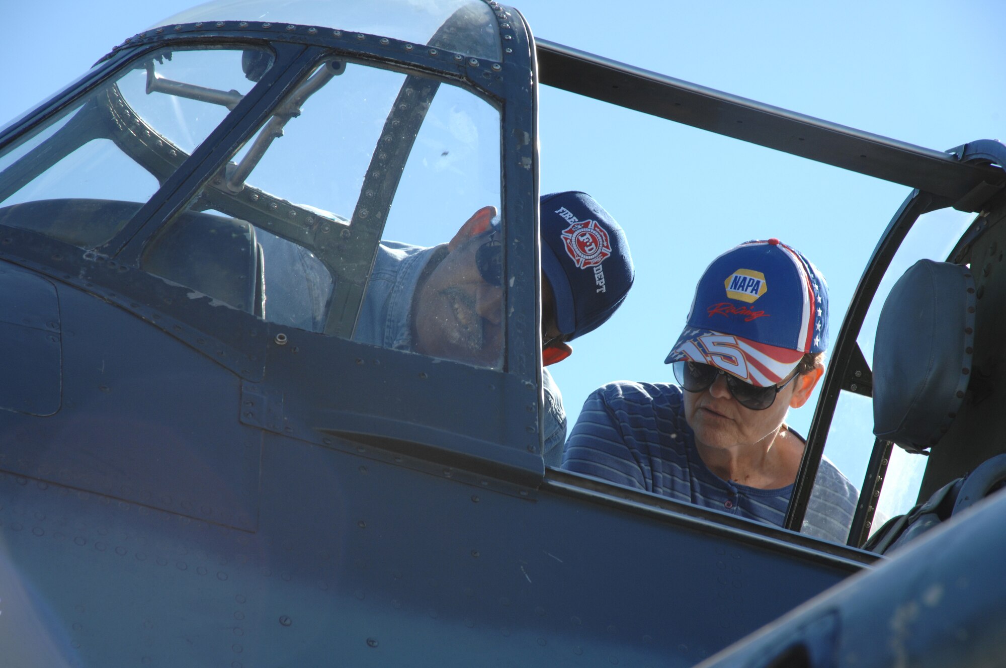 Gene and Georgia Davis of Alamogordo, N.M., take a look inside the cockpit of a TBM-3 Avenger Oct. 28, 2007, during the Holloman Air and Space Expo. The HASE is a showcase of Air Force capabilities, the 49th Fighter Wing mission and the X Prize Foundation. (U.S. Air Force photo by Airman 1st Class Jamal Sutter)