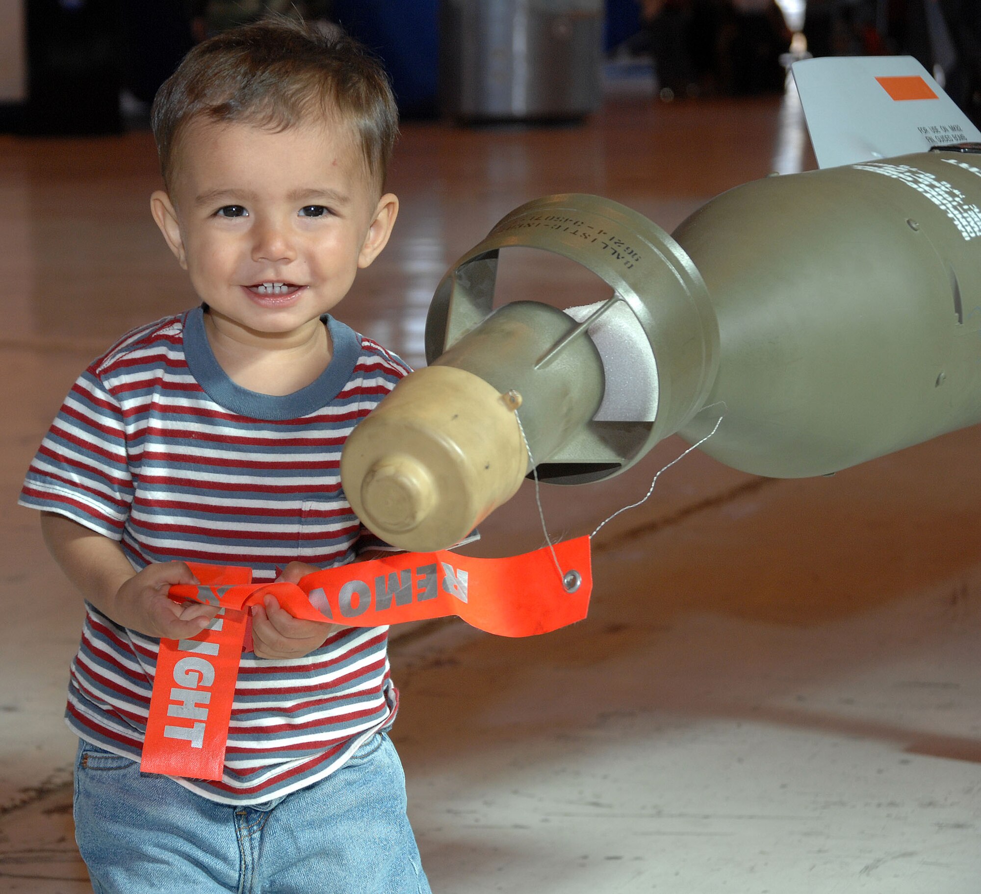 Capt. Micheal Driscoll's son, Jake, plays with a mock GBU-12. The simulated GBU-12 was on display during the Holloman Air and Space Expo at Holloman AFB, N.M., Oct. 28, 2007. The HASE is a showcase of Air Force capabilities, the 49th Fighter Wing mission, and the X Prize Foundation. (U.S. Air Force photo by Airman 1st Class Tiffany Trojca)