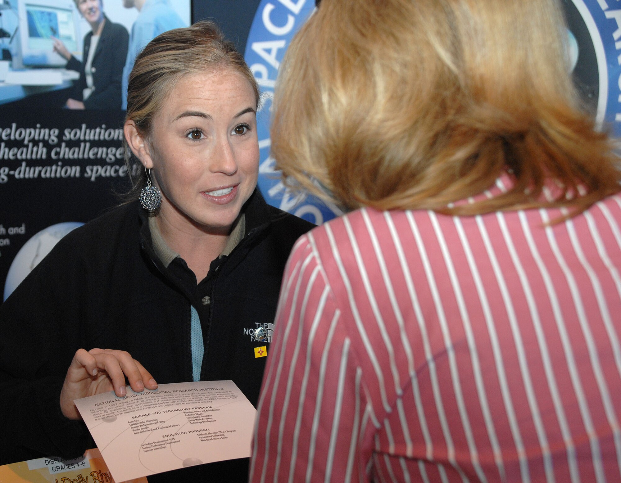 National Space Biomedical Research Institute's Senior Communications Specialist, Lauren Hammit, speaks to spectators attending the Holloman Air and Space Expo at Holloman AFB, N.M. Oct. 28, 2007. The HASE is a showcase of Air Force capabilities, the 49th Fighter Wing mission, and the X Prize Foundation. (U.S. Air Force photo by Airman 1st Class Tiffany Trojca)