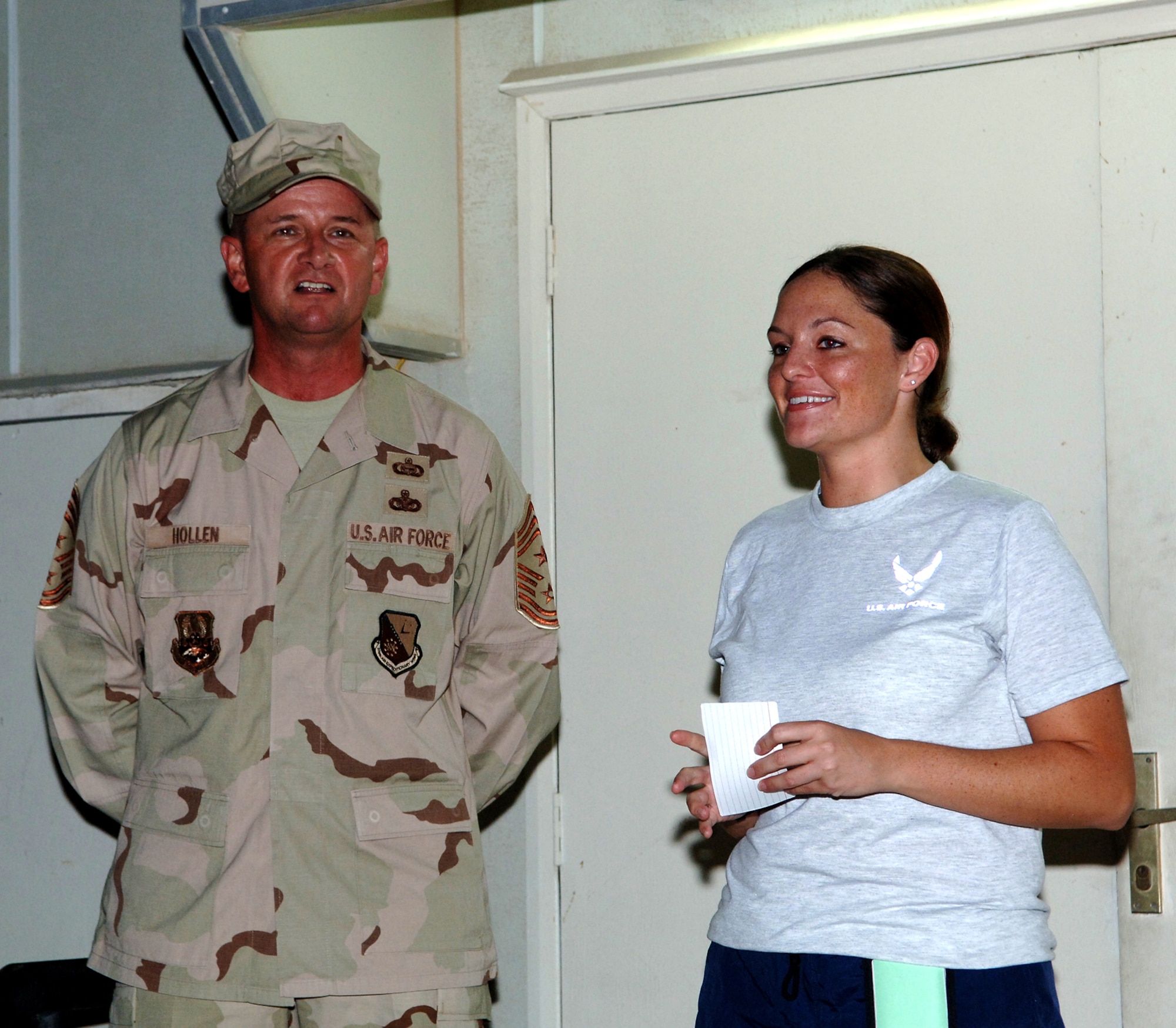 SOUTHWEST ASIA - Being deployed to Southwest Asia didn't deter Staff Sgt. Lea Musiol, 379th Expeditionary Communications Squadron from coordinating a Breast Cancer Awareness 5k Run/Walk and CFC Fundraiser during Wingman Week. With more than 240 participates for the cause, Musiol was coined for her efforts by Chief Master Sgt. Lloyd Hollen, Command Chief for the 379th Air Expeditionary Wing. (U.S. Air Force photo/Master Sgt. Greg Kunkle)