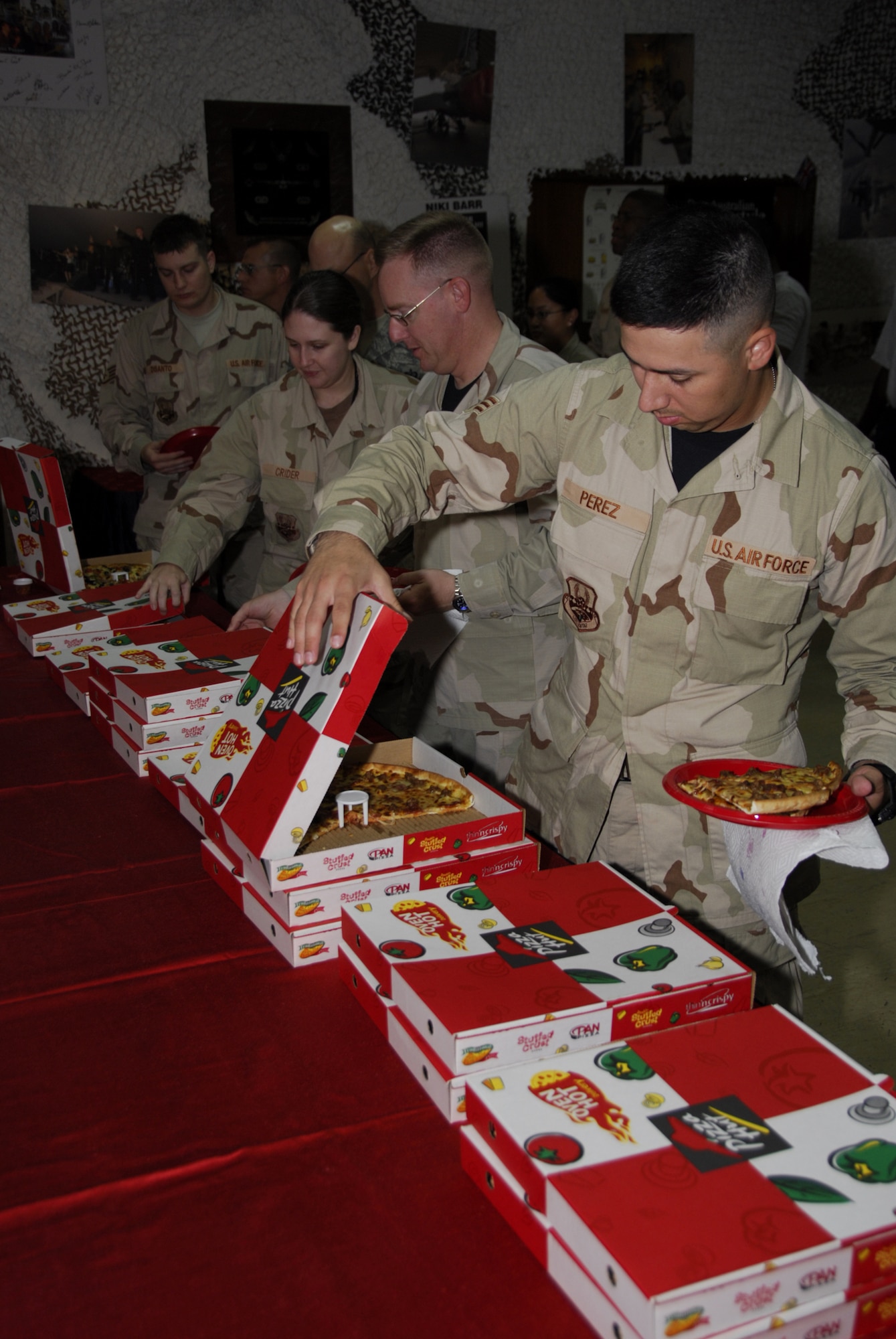 SOUTHWEST ASIA - Members of the 379th Air Expeditionary Wing line up for pizza at the desert Eagle Lounge. The pizza party was part of the wrap-up for the Wing Staff Agency?s Wingman Week Oct. 26. (U.S. Air Force photo/Staff Sgt. Douglas Olsen)