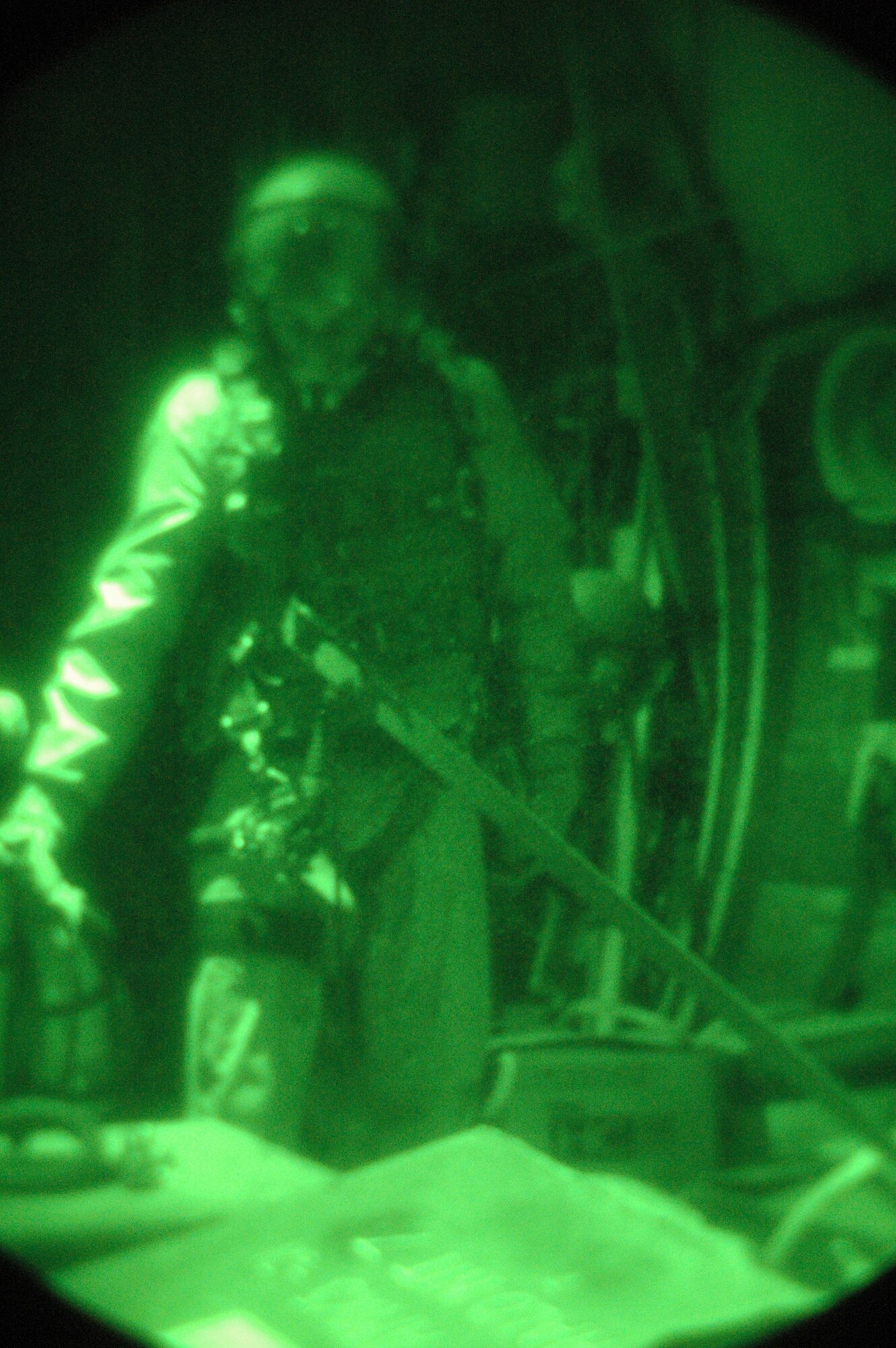 SOUTHWEST ASIA - Senior Airman William Moody, 40th Expeditionary Airlift Squadron, performs last minute checks prior to a night drop over Afghanistan. Becuase the drop is near enemy territory, low-level light is used to prevent the enemy from seeing and firing on the aircraft. (U.S. Air Force photo/Staff Sgt. Jason Barebo)