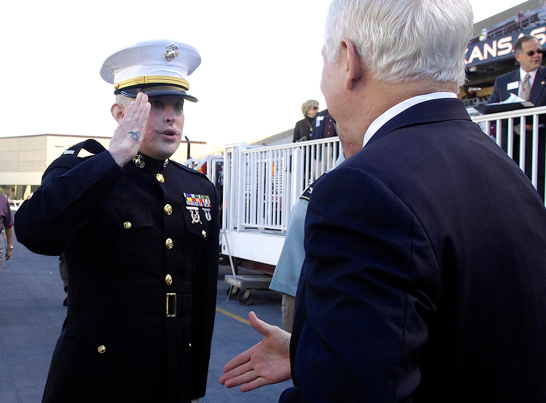 Marine 1st Lt. Dan Moran salutes Defense Secretary Robert M. Gates during the  University of Kansas-Texas A&M football game in College Station, Texas, Oct. 27, 2007.  Moran, a former Aggie wounded in Iraq is the recipient of the Navy Commendation Medal with Valor.