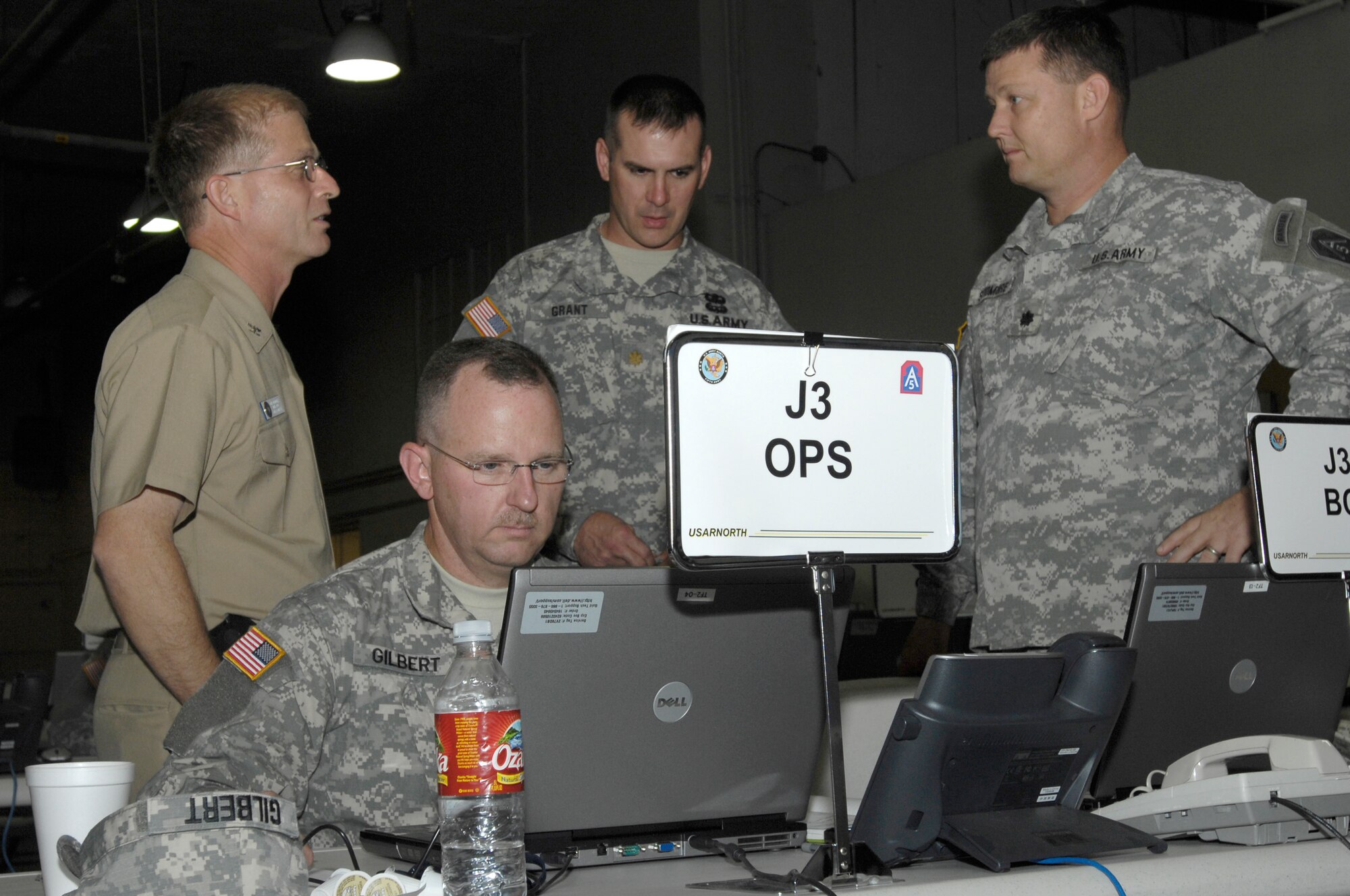 Capt. Eugene Dawydiak, left, Maj Andy Gilbert, Maj. Eric Grant and Lt. Col James Skidmore monitor and coordinate joint military efforts as part of a federal support package used to assist federal, state and local agencies responding to the California wildfires at March Air Force Base in Riverside, Calif., Oct. 25, 2007.  (U. S. Air Force photo by Senior Airman Daniel St. Pierre) 

