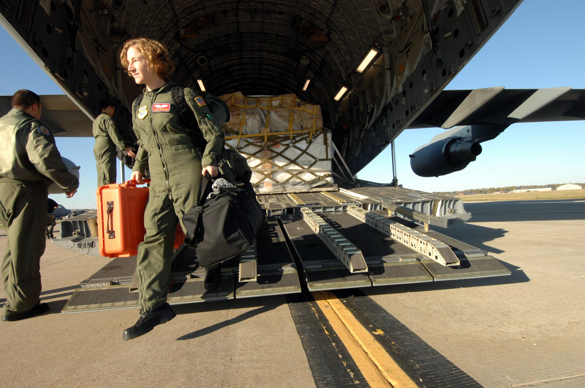 Members of the 375th AES arrive home at Scott AFB, IL as they exit a C17A Globemaster from 452nd AMW, March Air Reserve Base, Calif. The 375th AES was assigned to the Mobile Aeromedical Staging Facility at March Air Reserve Base, Calif., in support of medical relief efforts for the California wildfires. The 375th along with other aeromedical components from Pope AFB, N.C., and Travis AFB, Calif., were on standby to air-evacuate fire victims out of the local area. U.S. Air Force photo by MSgt Rick Sforza (RELEASED)