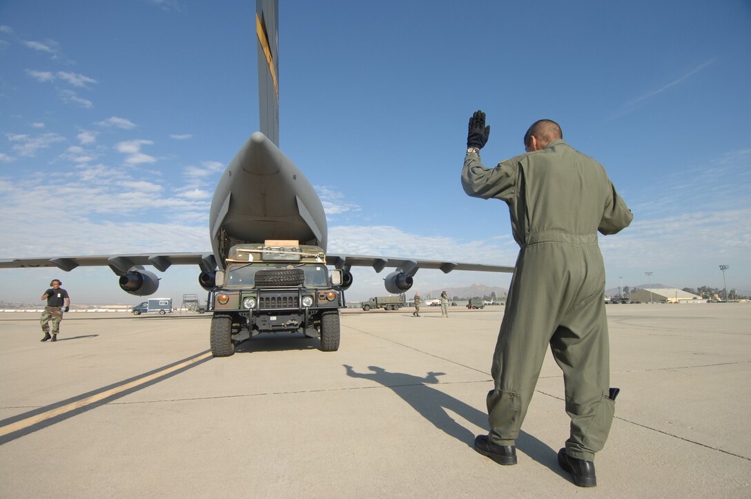 TSgt Sergio Melendez, a loadmaster from the 729th AS at March Air Reserve Base, Calif., loads a vehical into a C-17A Globemaster Sunday October 28th, 2007. The C17 crew is redeploying the 375th to Scott AFB, IL. The 375th AES was assigned to the Mobile Aeromedical Staging Facility at March Air Reserve Base, Calif., in support of medical relief efforts for the California wildfires. The 375th along with other aeromedical components from Pope AFB, N.C., and Travis AFB, Calif., were on standby to air-evacuate fire victims out of the local area. U.S. Air Force photo by MSgt Rick Sforza (RELEASED)