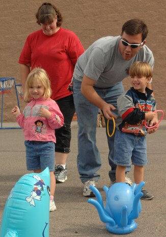 Staff Sgt. Wesley Going, airspace ground equipment mechanic with the 57th Equipment Maintenance Squadron, spends the day with his wife Jeanette and two children, 3-year-old Alyssa and 4-year-old Nathen, at the Youth Center during the Harvest Festival on Nellis Air Force Base, Nev., Oct. 27. The festival is an event held at the Youth Center annually. The event featured a variety of games and prizes.
(U.S Air Force Photo by Airman Stephanie Rubi) 