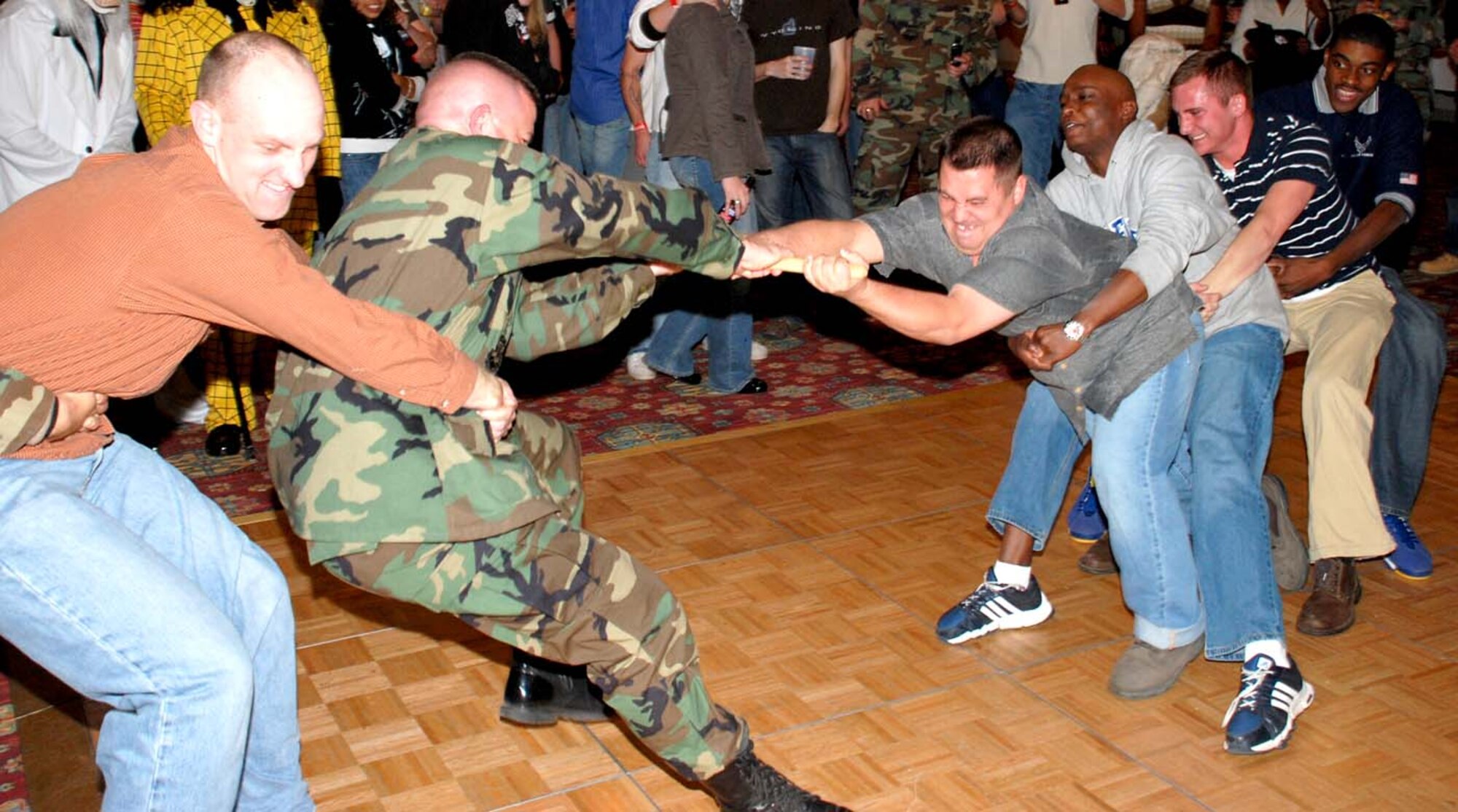 The 90th Security Support Squadron competes against the 90th SFS in a “broom pull” at the 90th SFG Club Warren Oct. 19. Other events included a food eating contest and a dizzy bat challenge.