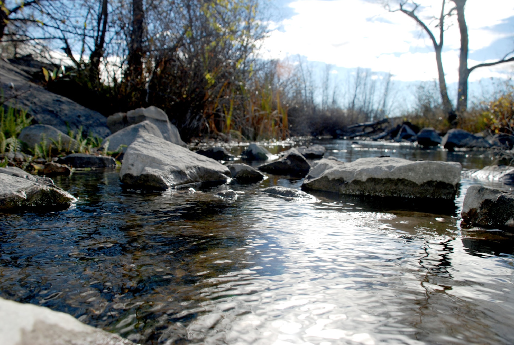 Crow Creek can flow easier after a volunteer clean up Oct. 19. The 90th Civil Engineer Squadron hosted the event. Volunteers were offered free coffee donuts during a pre-clean up briefing (Photo by Staff Sgt. Kurt Arkenberg).