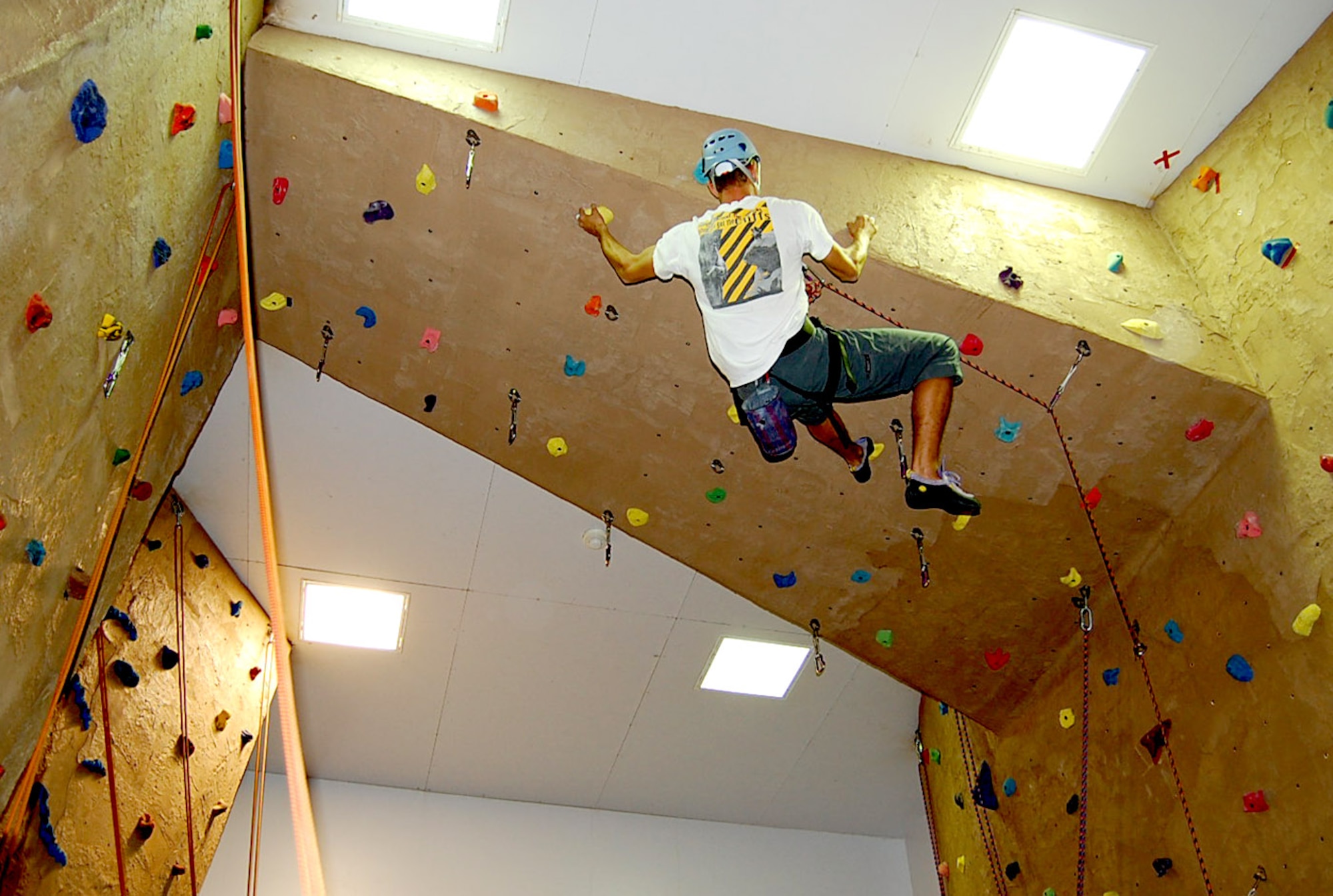 First Lt. Bryant Bevan, 37th Helicopter Squadron, reaches the top of the rock wall in the Fall Hall Community Center. The community center holds certification courses the second and fourth Tuesday of every month. For more information call 773-3510 (Courtesy Photo).
