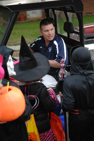 MOODY AIR FORCE BASE, Ga -- Senior Master Sgt. Michael Claiborne, 723rd Aircraft Maintenance Squadron first sergeant., gives out light sticks to children tirick-or-treating in Moody Family Housing Oct 27. (U.S. Air Force Photo by Master Sgt. Michael Featherston)
