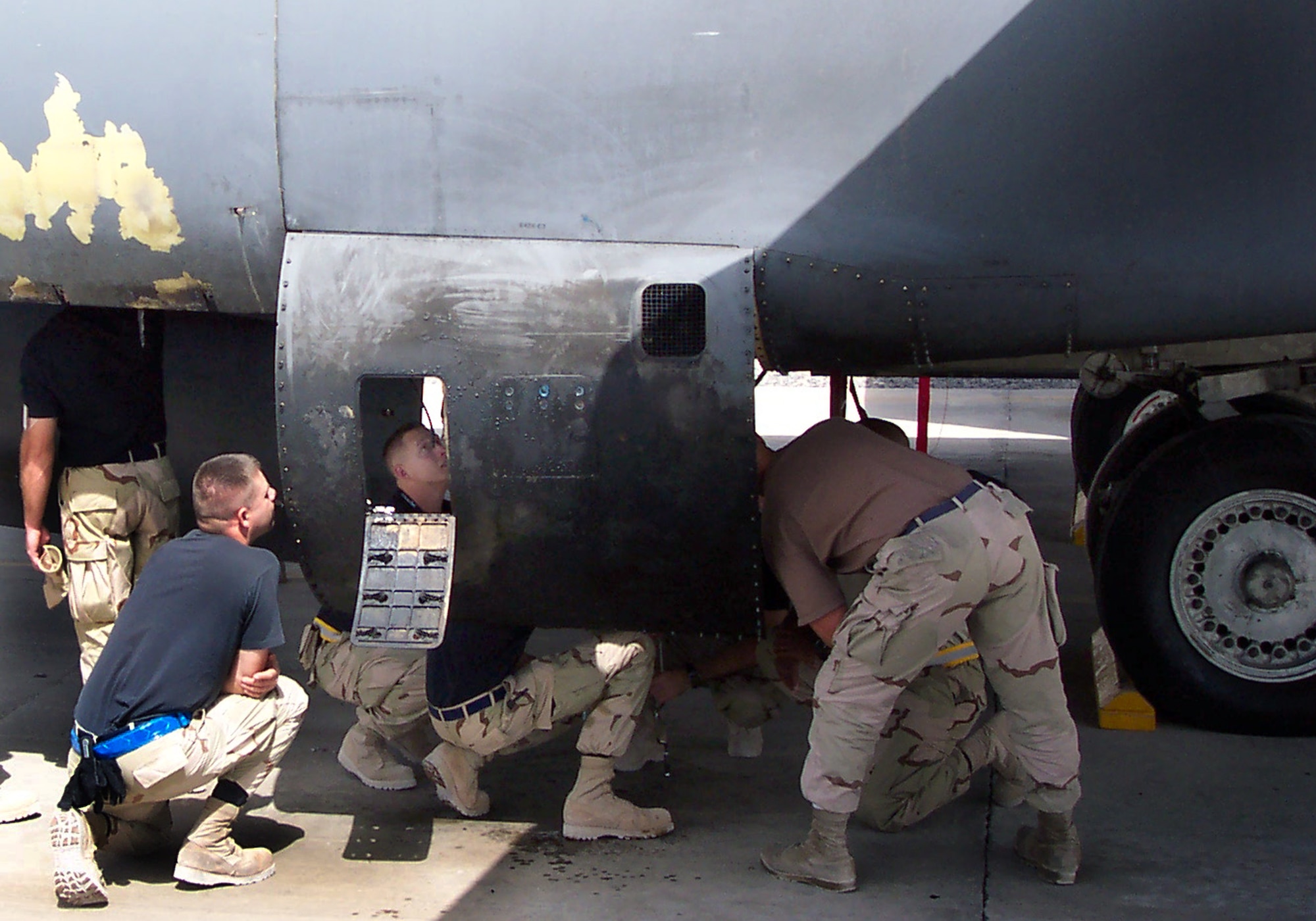 Airmen from the 654th Combat Logistics Support Squadron examine the damaged B-1B Lancer at a forward operating location within the U.S. Central Command area of responsibility. The 654th CLSS is located at Tinker Air Force Base, Okla. (U.S. Air Force photo) 