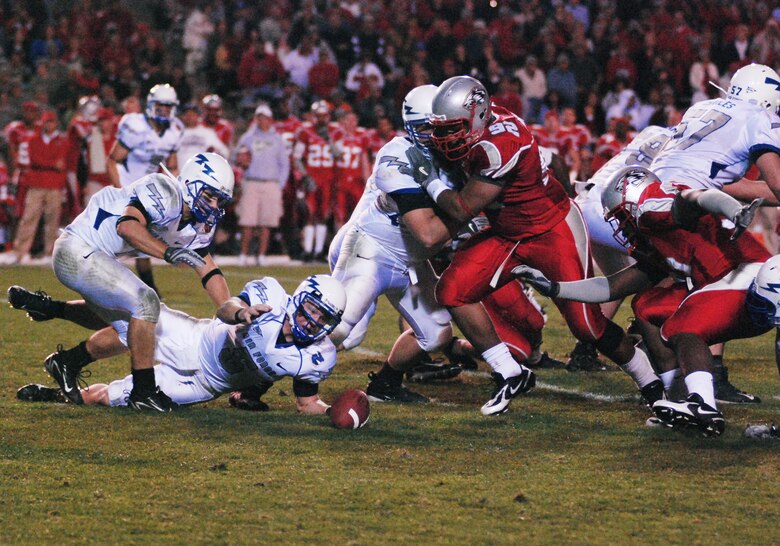 Falcon quarterback Shaun Carney dives for a fumbled snap during Air Force's 34-31 loss to the New Mexico Lobos Oct. 25 at University Stadium in Albuquerque. The fumble was one of five turnovers committed by the bluesuiters. (U.S. Air Force photo/Denise Navoy)     