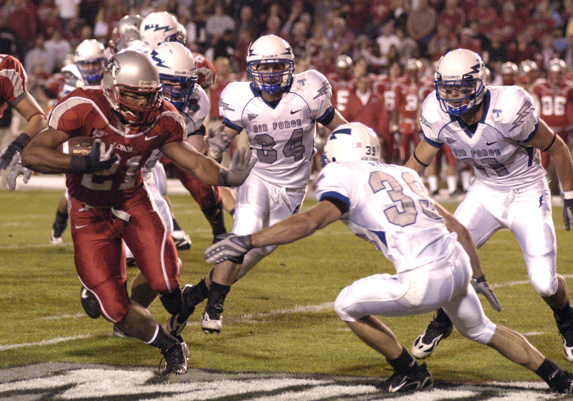 New Mexico tailback Rodney Ferguson tries to elude Falcon cornerback Garrett Ryback, 39, during the Lobos 34-31 win over Air Force Oct. 25 at University Stadium in Albuquerque. Ferguson ran a game-high 41 times for 146 yards and two touchdowns. (U.S. Air Force photo/John Van Winkle)       