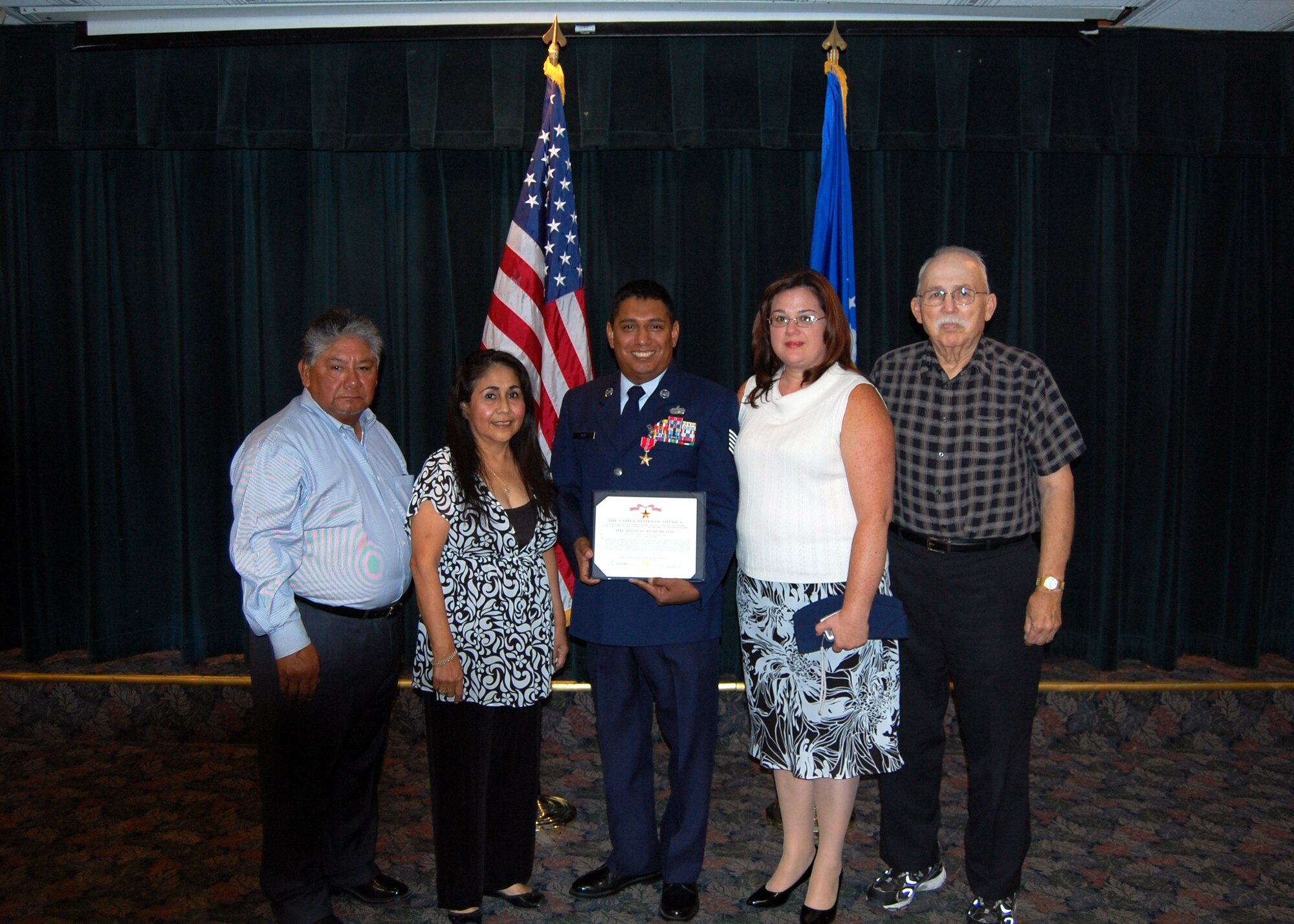 LAUGHLIN AIR FORCE BASE, Texas -- Tech. Sgt. Natividad Ruiz, Jr., stands for a picture with his family after receiving the Bronze Star Medal for actions during a one-year combat tour in Iraq. Sergeant Ruiz averted a potentially deadly riot at his Iraqi Army Base when suspected insurgent activity threatened the base's food supply chain. Pictured from left are Natividad Ruiz, Sr., mother Delia Cook, Sergeant Ruiz, spouse Patty, and father in law Air Force Lt. Col. Joe Taylor, retired. Sergeant Ruiz married Patty the morning he was awarded the Bronze Star. He returned to duties with the 47th Force Support Squadron Oct. 8. (U.S. Air Force Photo/Capt. Ken Hall)