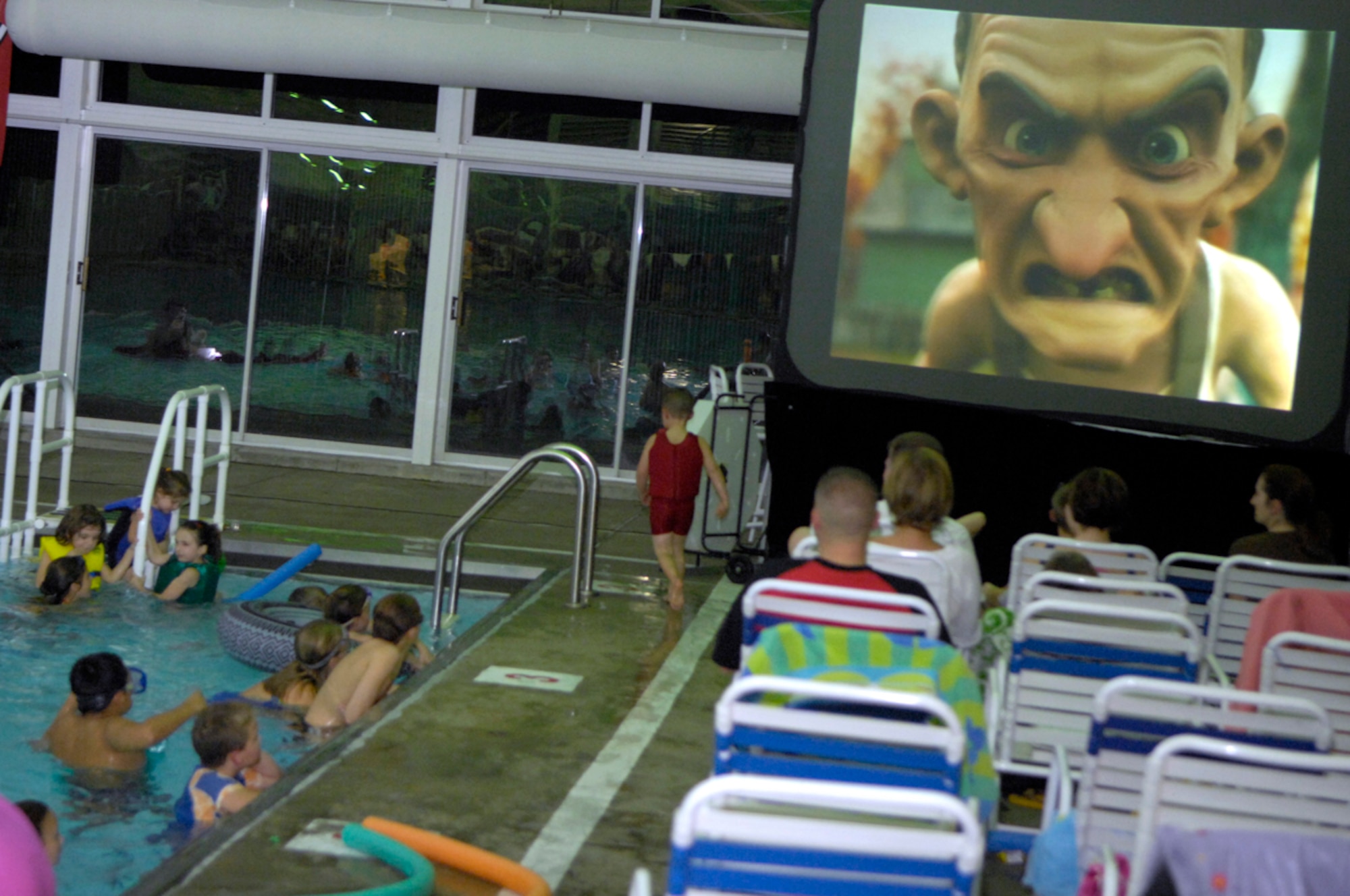 HANSCOM AFB, Mass. -- Base children and parents enjoy an evening of swimming and movie entertainment at the Base Pool Oct. 26. In honor of Halloween, the movie shown during this month’s Flick and Float event was "Monster House." (U.S. Air Force photo by Mark Wyatt)

