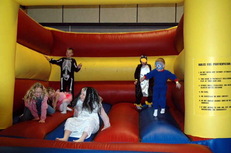 Little Warriors bounce around in the Jolly Jumper at the Youth Programs Center's Fall Festival Oct. 26. While the Jolly Jumper is always a hit, there were many games, prizes and refreshments for the costumed children to enjoy as well. (U.S. Air Force photo/Airman 1st Class Emerald Ralston)