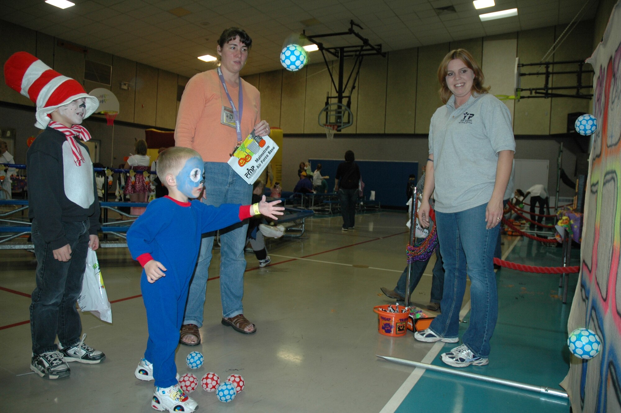 Little Warrior Daniel, 3, tosses a ball at the Tic Tac Toss board at the Youth Programs Center's Fall Festival Oct. 26. (U.S. Air Force photo/Airman 1st Class Emerald Ralston)
