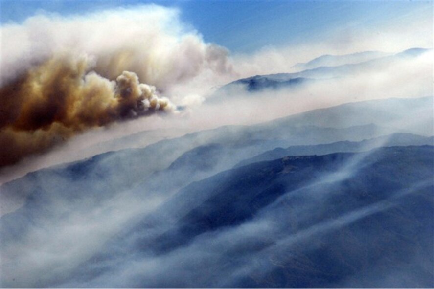 Heavy smoke hangs in the air as the Poomacha Fire in northern San Diego County, Calif., continues to burn on Oct. 26, 2007. Crews on six specially equipped Air Force C-130 Hercules aircraft are supporting firefighting efforts by strategically releasing fire retardant in the area. (U.S. Air Force photo/Tech. Sgt. Roy A. Santana)