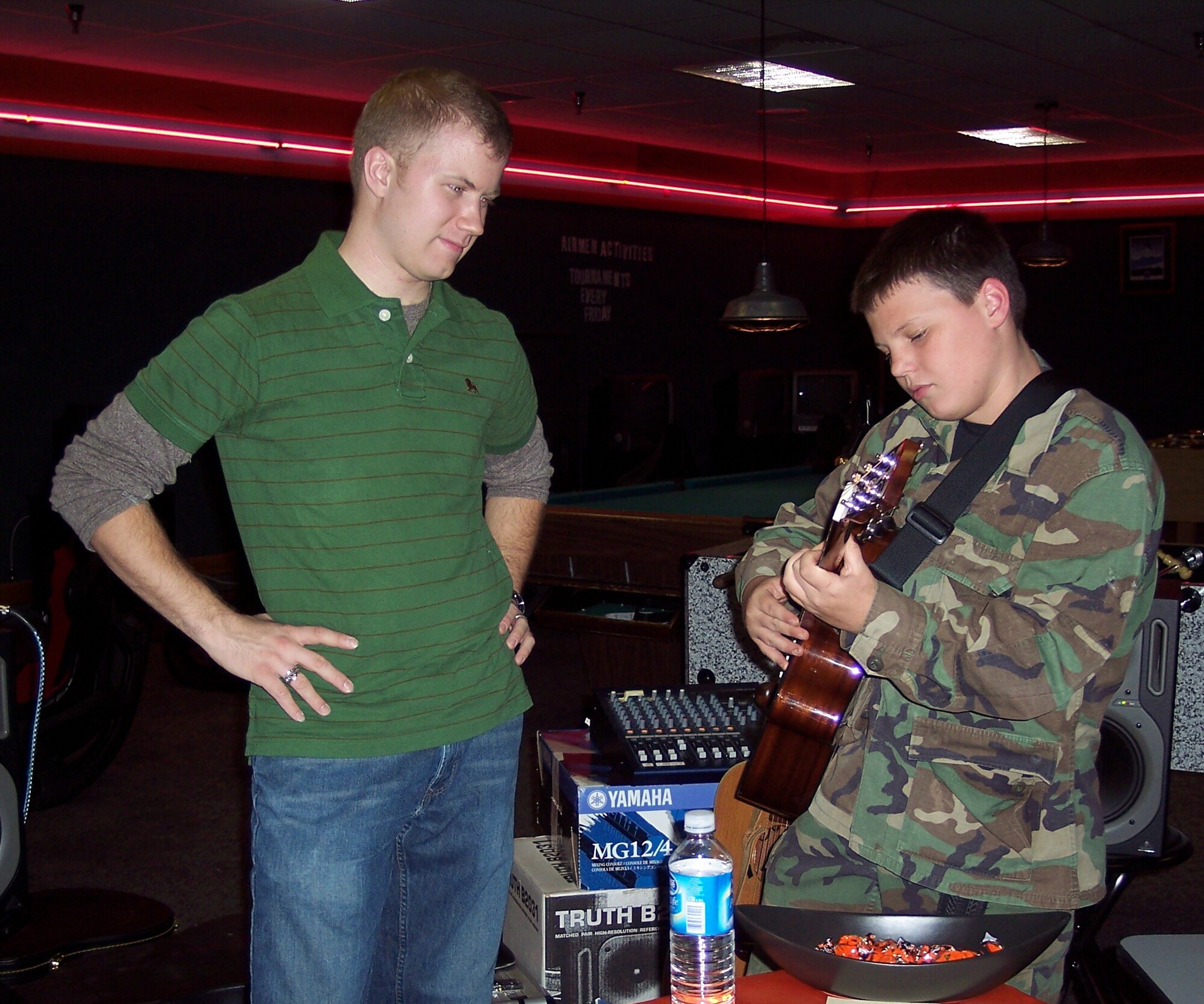 WHITEMAN AIR FORCE BASE, Mo. - First Lt. Timothy Pitzer, 509th Maintenance Operations Squadron, instructs Tim Allen, son of Master Sgt. Timothy Allen, 509th Communications Squadron, in a guitar class during “Boo Bash” at the Whiteman Youth Center Oct. 27. Along with guitar classes, other instructional classes currently being offered at the youth center are: karate, piano and Spanish. Anyone interested in signing up may contact the youth center at 687-5586. (Photo printed with permission of Sharon Gangemella) 