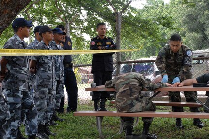 SOTO CANO AIR BASE, Honduras -- Air Force Staff Sgt. Edgar Castro, Joint Security Forces, logs evidence from simulated victims during a training class with police from nearby Comayagua and La Paz police divisions, as well as cadets from the La Paz Police Academy.  The crime scene processing course is one in a series of classes taught this year, with other lessons involving handcuff procedures, high-risk traffic stops and riot control.  (U.S. Air Force photo/Tech. Sgt. Sonny Cohrs)