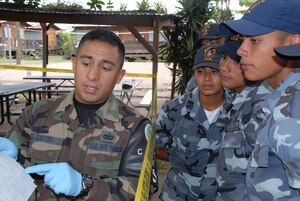 SOTO CANO AIR BASE, Honduras -- Air Force Staff Sgt. Edgar Castro, Joint Security Forces, explains crime scene processing paperwork to students from the La Paz Police Academy during a training course here.  The crime scene processing class is one in a series of classes taught this year, with other lessons involving handcuff procedures, high-risk traffic stops and riot control.  (U.S. Air Force photo/Tech. Sgt. Sonny Cohrs)