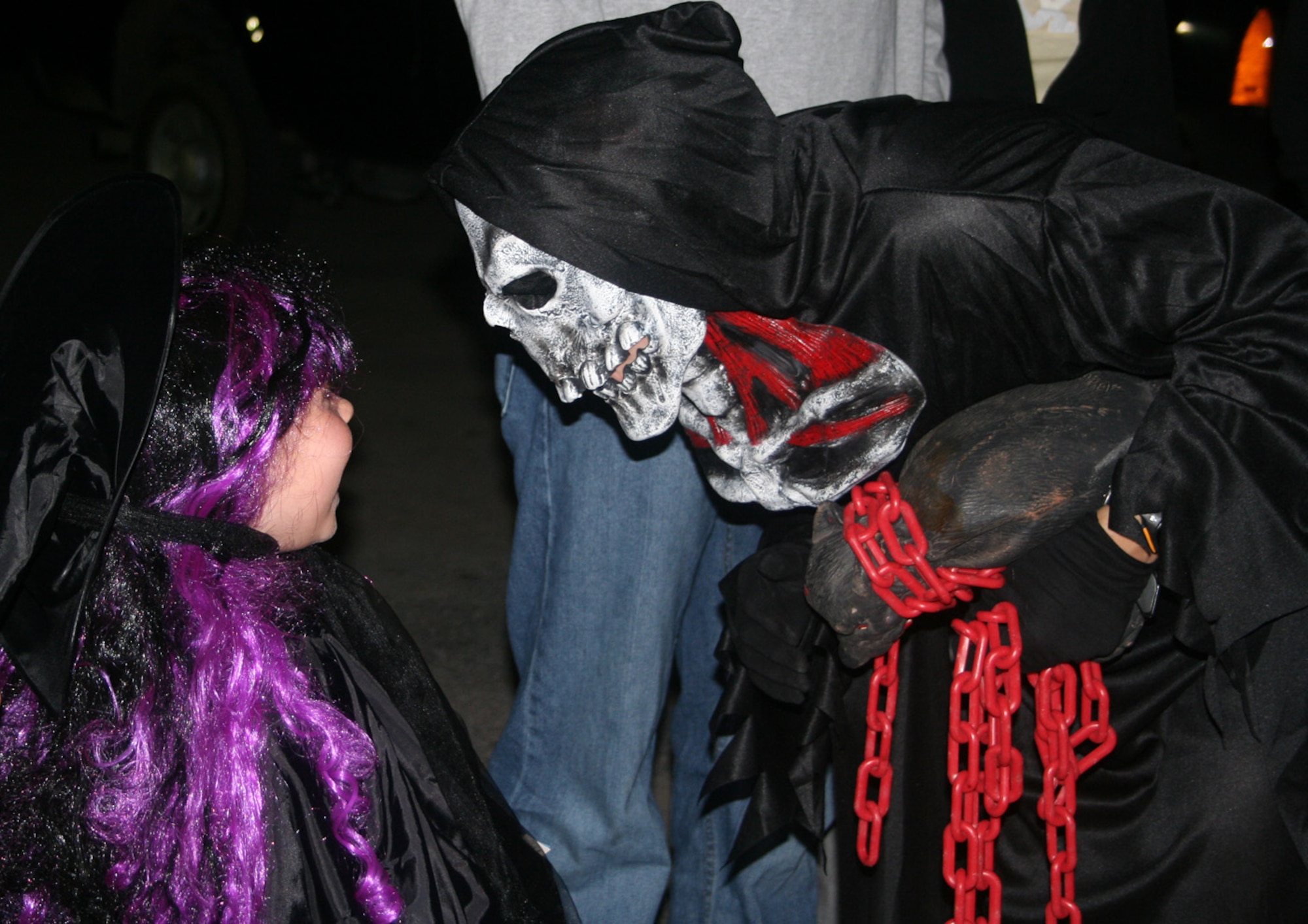 A "monster" from the 823rd RED HORSE Squadron haunted house spends a little time with a visitor before she ventures inside Oct. 26. The haunted house, an 823rd RHS tradition for nearly 20 years at Hurlburt Field, is open for one final night of scaring Oct. 31. (U.S. Air Force photo by Tech. Sgt. Angela Shepherd)