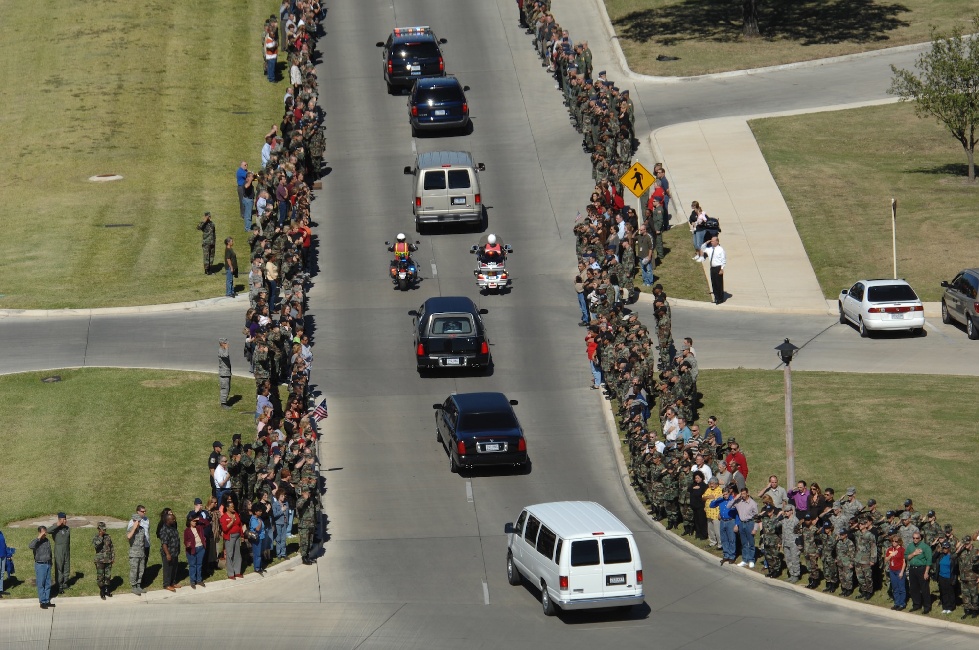 Hundreds of men and women at Randolph Air Force Base, Texas, line the streets Oct. 26 as a show of respect for U.S. Army Spc. Vincent A. Madero, a soldier killed while supporting Operation Iraqi Freedom.  Specialist Madero died Oct. 17 in Balad, Iraq, of wounds suffered when an improvised explosive device detonated near his Humvee.  Specialist Madero's body was flown to Randolph AFB and received by his family.  (U.S. Air Force photo/Richard McFadden)