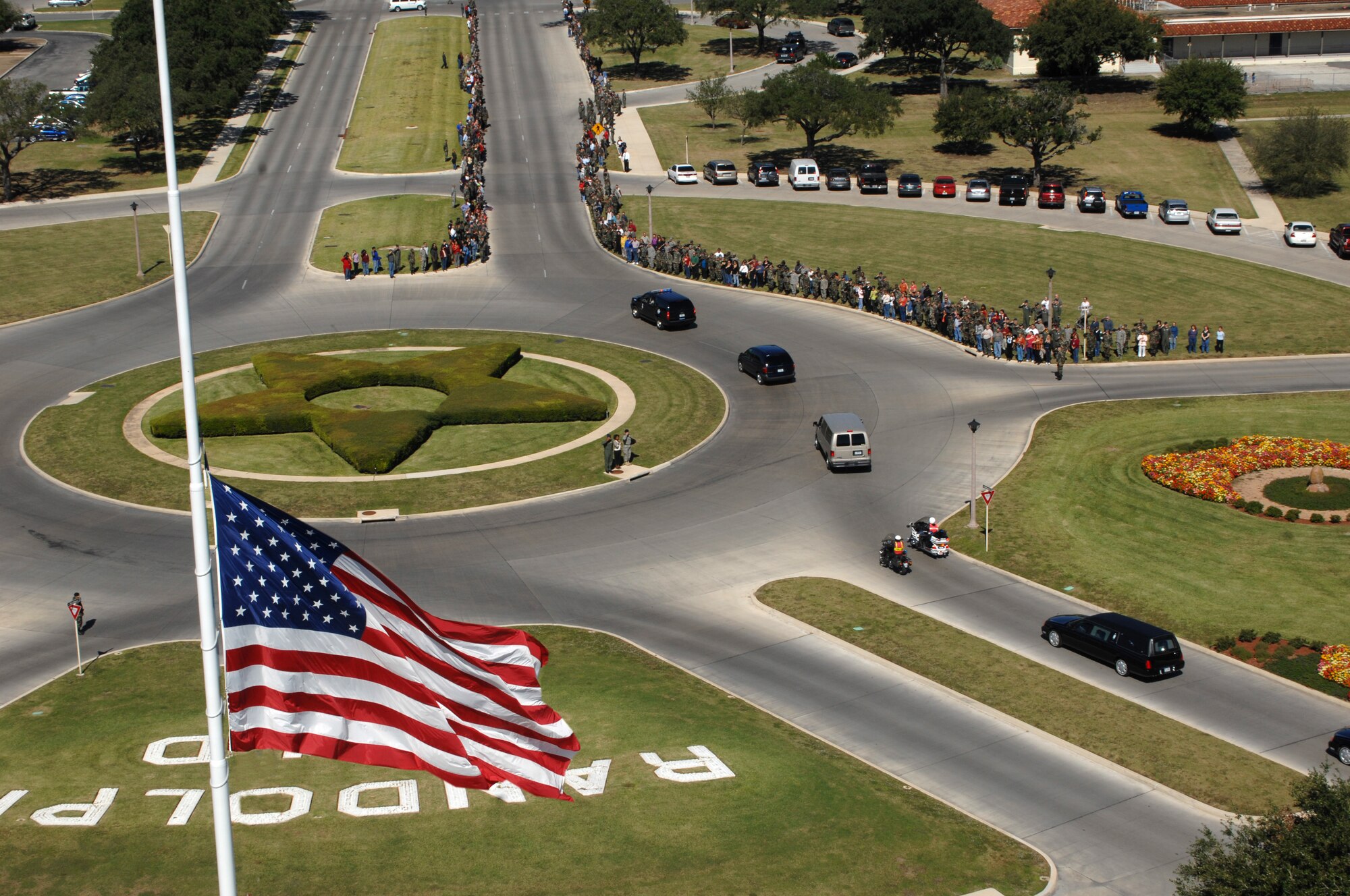 Hundreds of men and women at Randolph Air Force Base, Texas, line the streets Oct. 26 as a show of respect for U.S. Army Spc. Vincent A. Madero, a soldier killed while supporting Operation Iraqi Freedom.  Specialist Madero died Oct. 17 in Balad, Iraq, of wounds suffered when an improvised explosive device detonated near his Humvee.  Specialist Madero's body was flown to Randolph AFB and received by his family.  (U.S. Air Force photo/Joel Martinez)