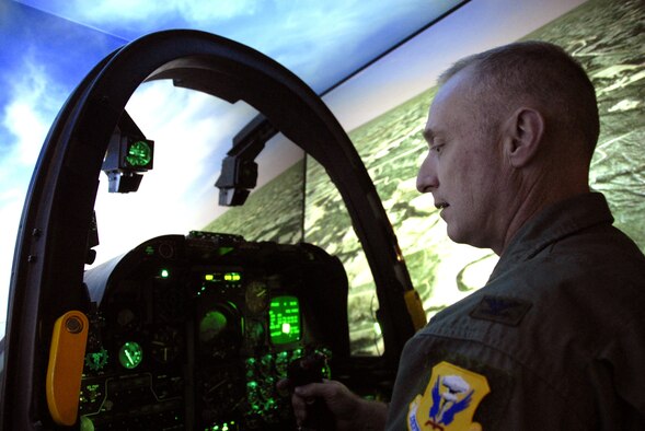 Col. Garrett Harencak, 509th Bomb Wing commander, takes a turn in the 442nd Fighter Wing's A-10 simulator Oct. 25, 2007, at Whiteman Air Force Base, Mo.  Colonel Harencak visited the 442nd, an Air Force Reserve Command unit, for the first time since taking command of the 509th in September.  The 509th Bomb Wing is the active-duty host unit at Whiteman and flies the B-2 Spirit, or "Stealth," bomber.  Pilots from the 442nd FW's 303rd Fighter Squadron familiarized the colonel with the A-10 Thunderbolt II's close air support mission.  Colonel Harencak also received a mission briefing on the reserve unit and issues unique to Air Force reservists.  (U.S. Air Force photo/Maj. David Kurle)
