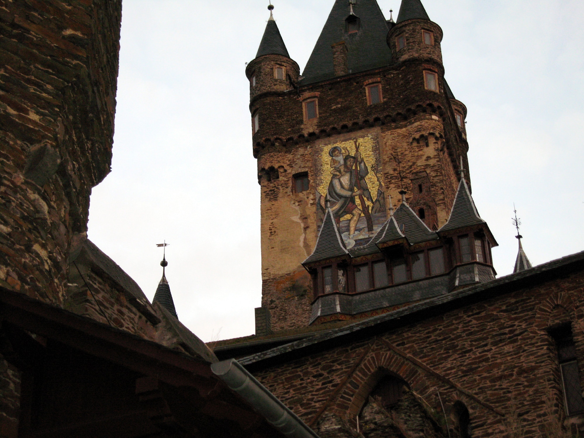 SPANGDAHLEM AIR BASE, Germany – A mural of St. Christopher, the patron saint of travelers, painted on the side of Cochem Castle, greets visitors as they make the walk to the castle. The Information, Trips and Travel office offers a Cochem Castle tour and medieval dinner Nov. 24. (U.S. Air Force photo/Staff Sgt. Tammie Moore)