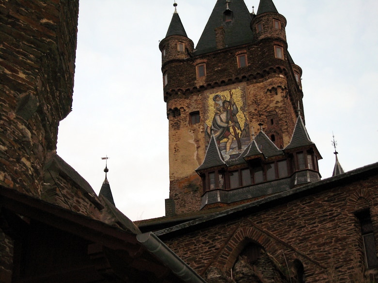 SPANGDAHLEM AIR BASE, Germany – A mural of St. Christopher, the patron saint of travelers, painted on the side of Cochem Castle, greets visitors as they make the walk to the castle. The Information, Trips and Travel office offers a Cochem Castle tour and medieval dinner Nov. 24. (U.S. Air Force photo/Staff Sgt. Tammie Moore)