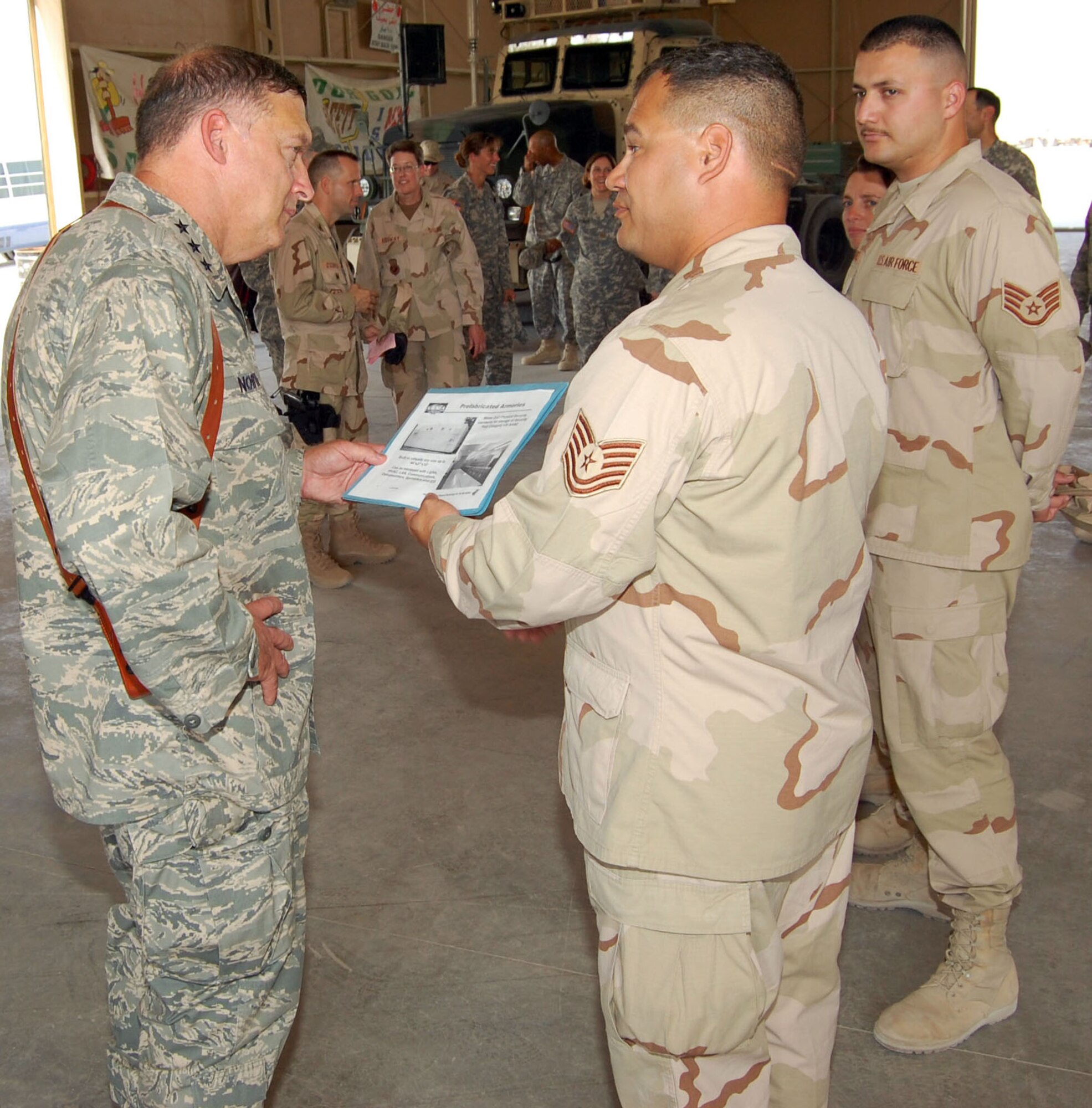 SOUTHWEST ASIA -- Lt. Gen. Gary North, 9th Air Force and U.S. Central Command Air Forces commander, listens to Tech. Sgt. Jason Gagnon, 70 Medium Truck Detachment NCO in charge, as he explains some new plans for an arms room Oct.26 in an undisclosed location. Sergeant Gagnon and General North had deployed together before and this was a reunion 15 years in the making. (Air Force photo by Staff Sgt Phillip Butterfield)